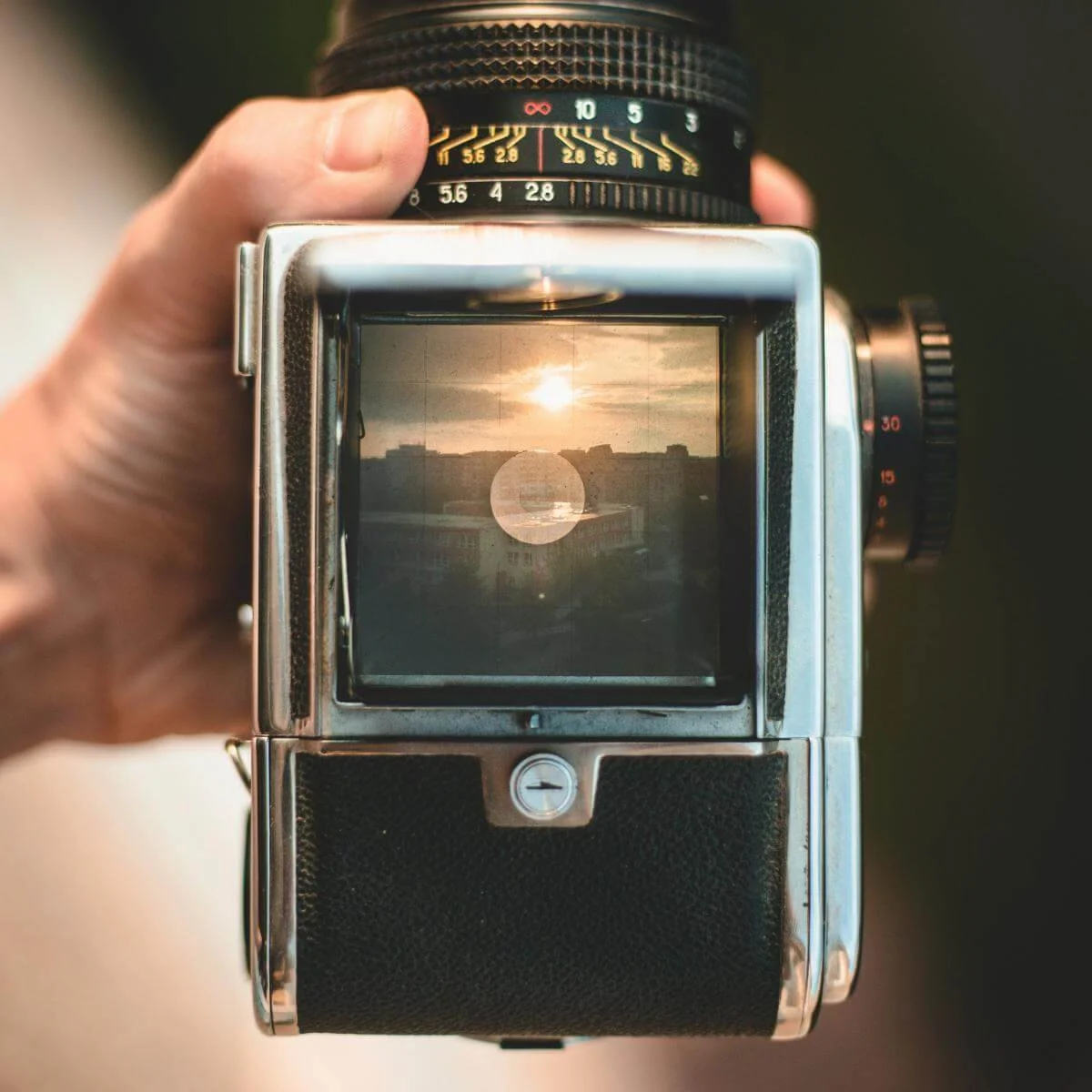 a sunrise viewed through the viewfinder of a vintage camera
