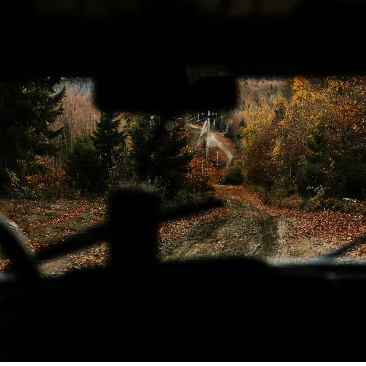 a mountain road through a windshield