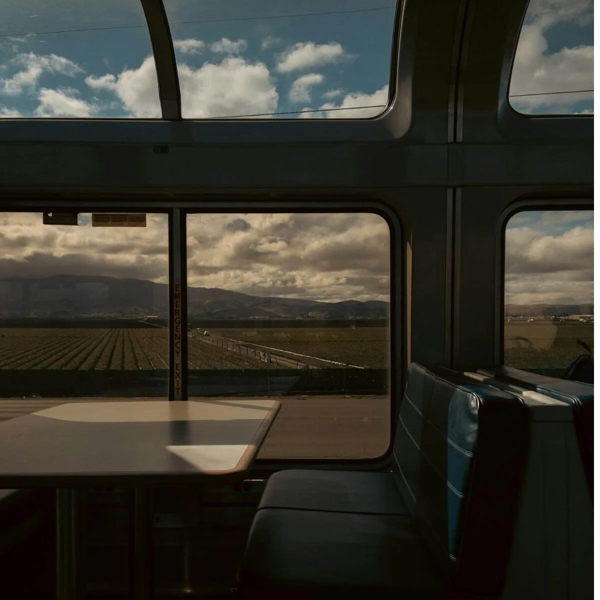 looking out windows of an Amtrak observation car