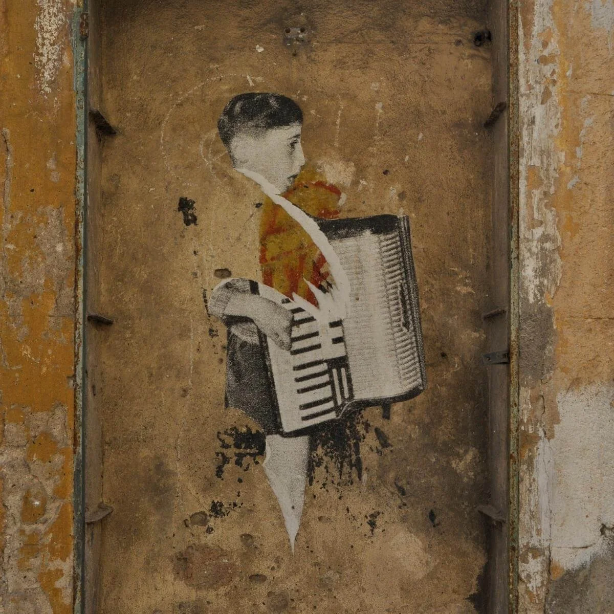 street art showing a boy playing the accordion