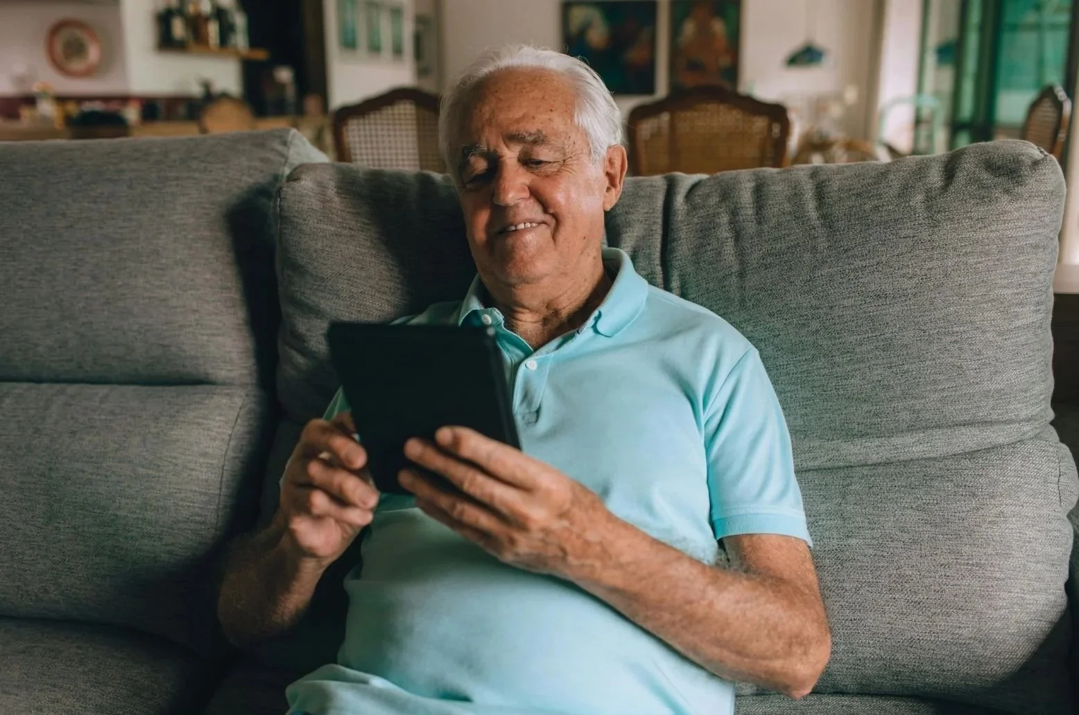 Elderly parent watching video message compilation from family members