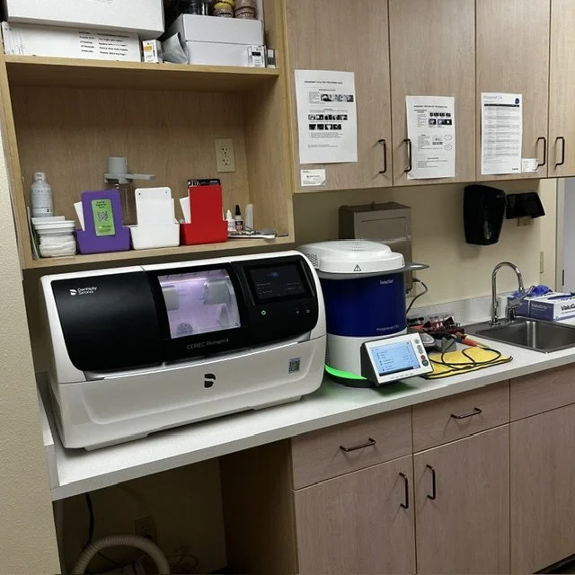 Medical laboratory countertop with a digital medical instrument, a container with a cleaning solution, a small tablet, and a sink.