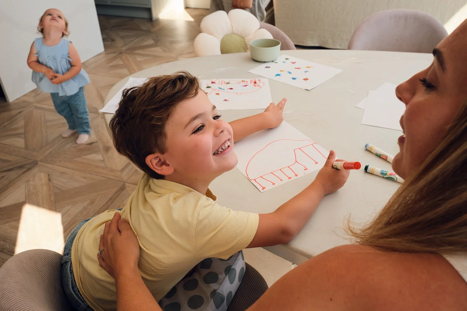 Family newborn photography Leeds children drawing and playing with mother