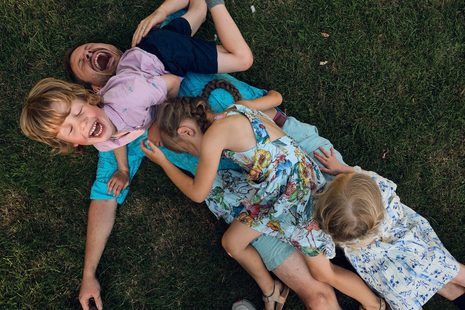 Event photography Leeds - Children playing at a party piling in top if their uncle