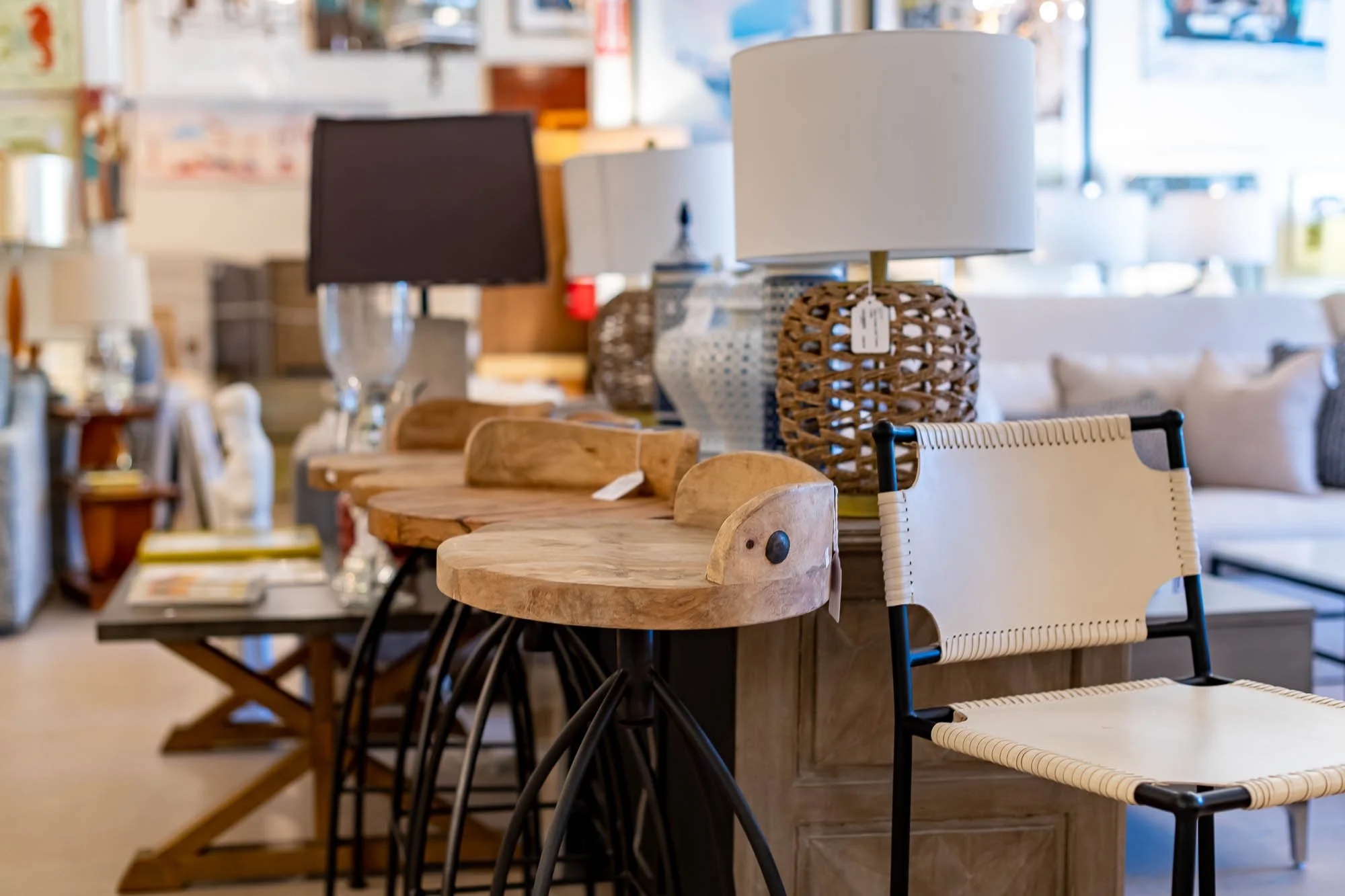 Display of various table lamps and chairs in a furniture store.