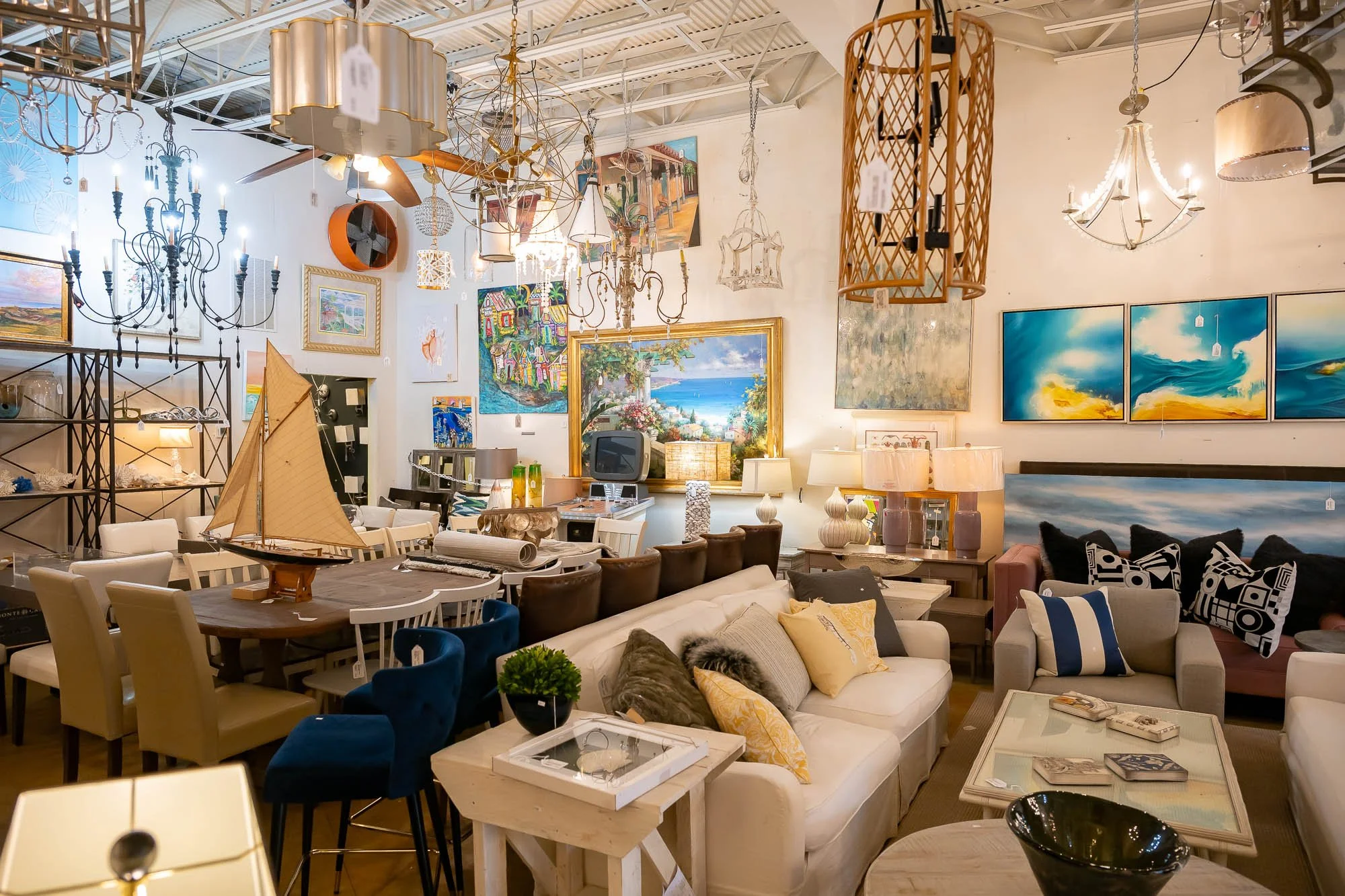 A room filled with furniture, artwork, and lighting fixtures.