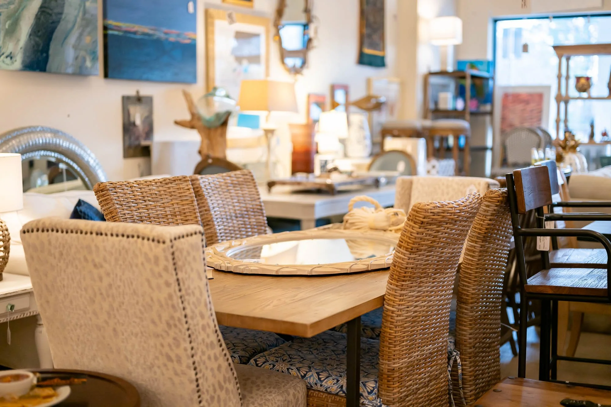 Indoor furniture store displaying various chairs, tables, and home decor items arranged in a cozy, well-lit space.
