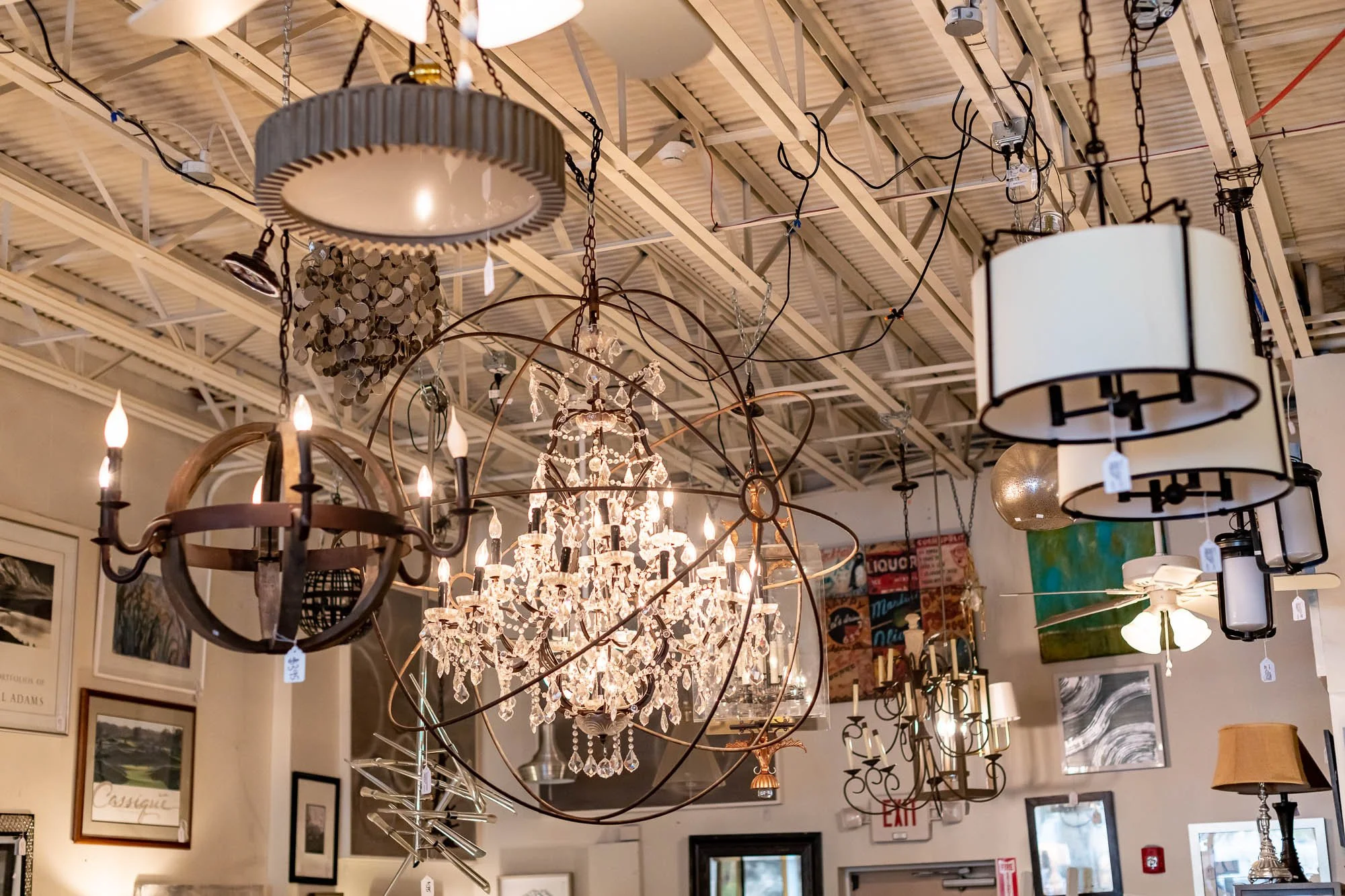 Various ceiling chandeliers and light fixtures in a lighting store.