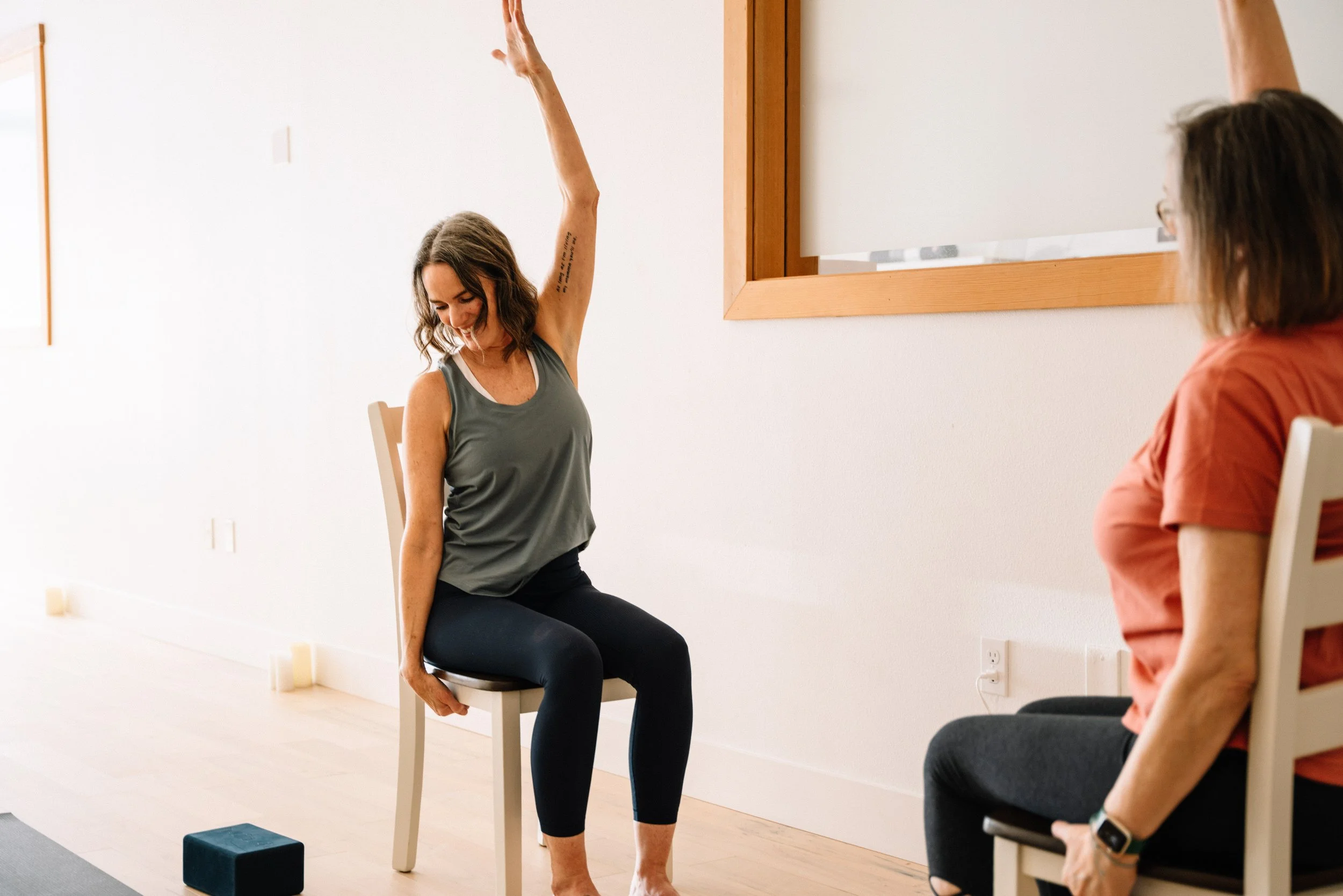 Instructor leading a gentle seated arm stretch