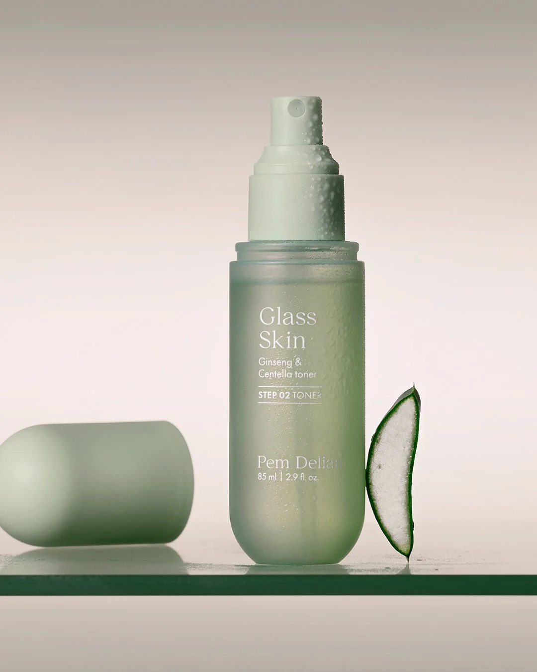 Close-up of Pem Delian Glass Skin Ginseng & Centella toner dripping from a dropper.