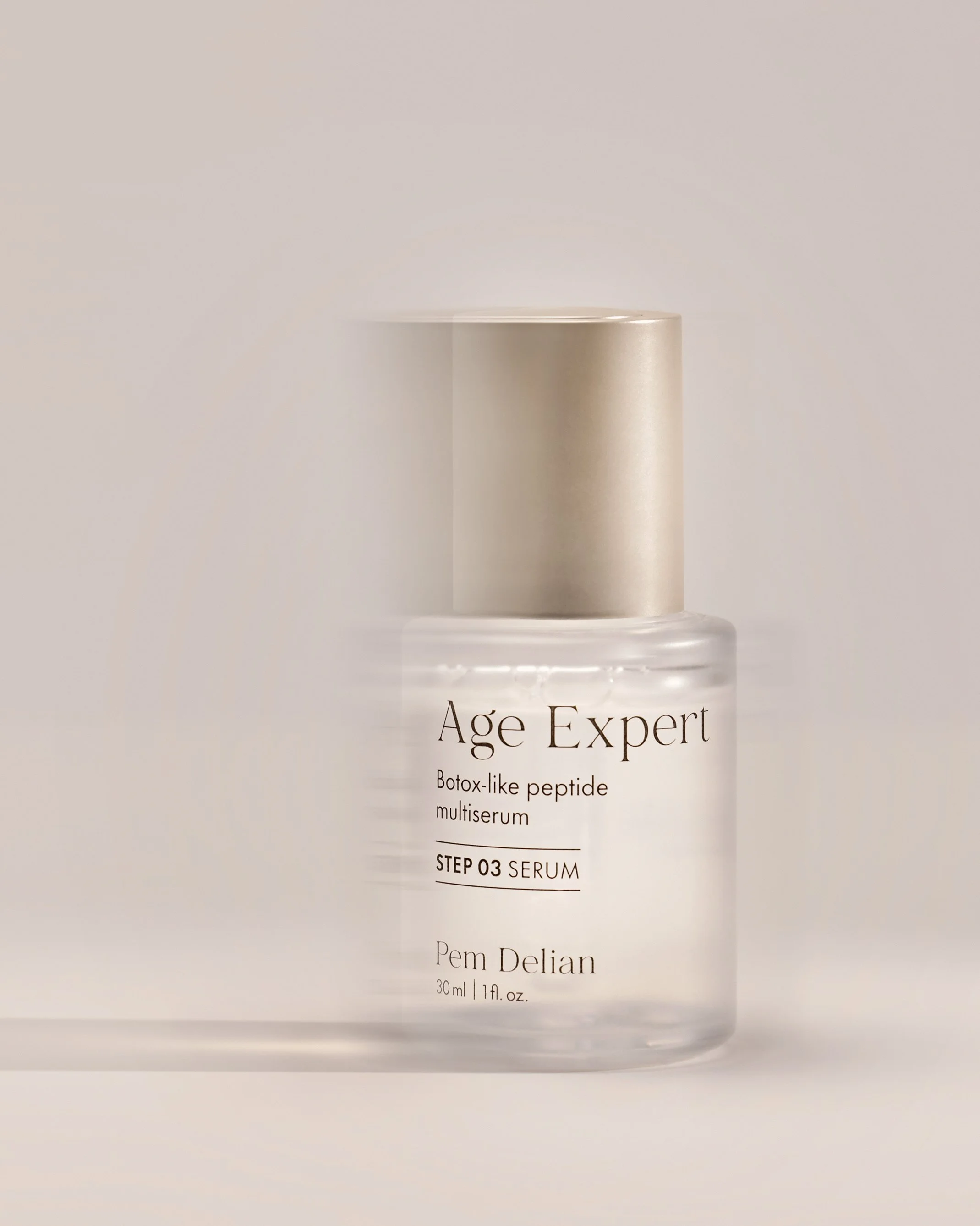 Pem Delian Age Expert Botox-like peptide multiserum 30ml bottle with gold cap on warm beige studio background