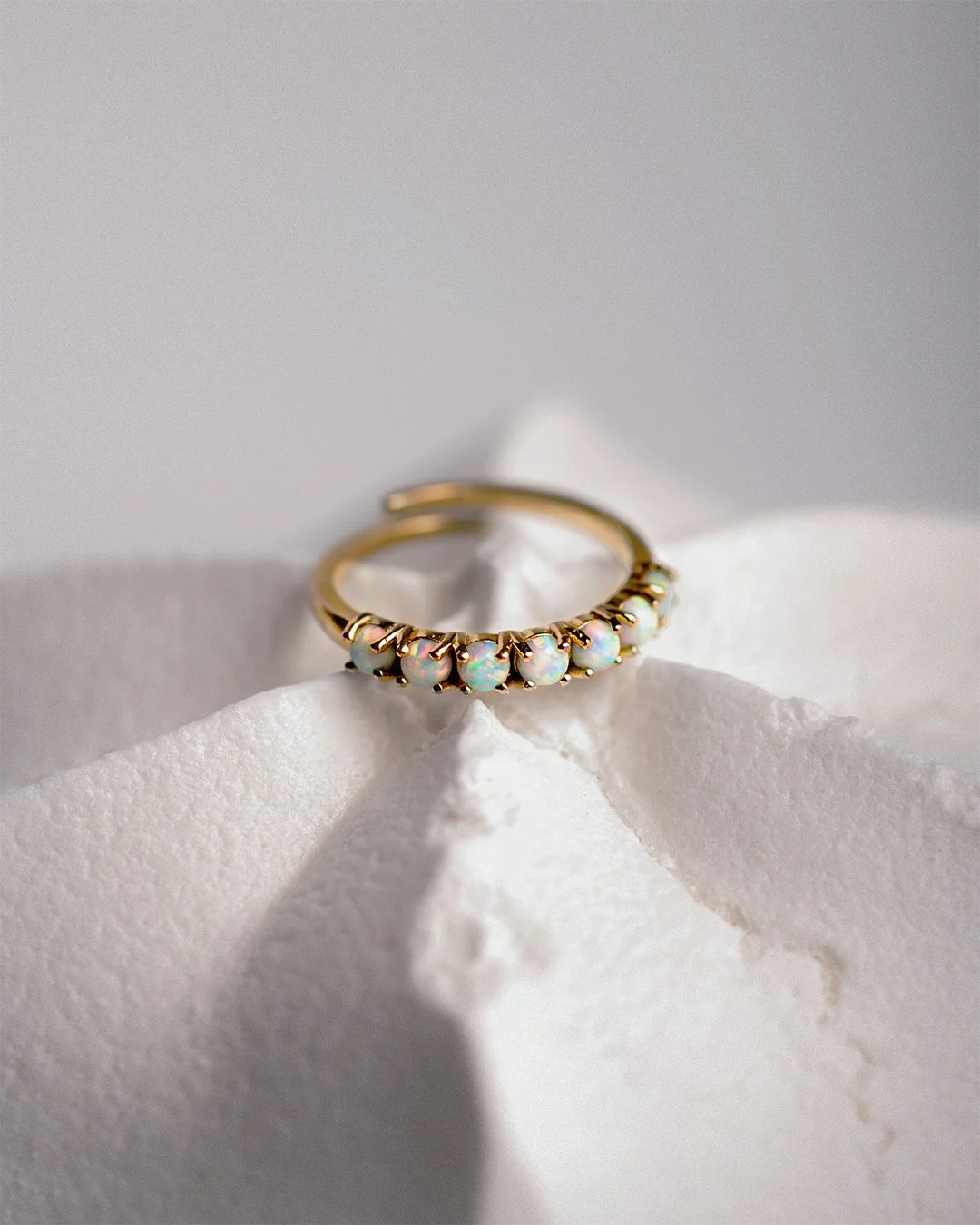 A study in contrast — cool opal fire held inside a warm, fractured sugar shell. Shot as part of a personal series exploring texture and material behavior in jewelry photography, where the prop does as much storytelling as the piece itself.