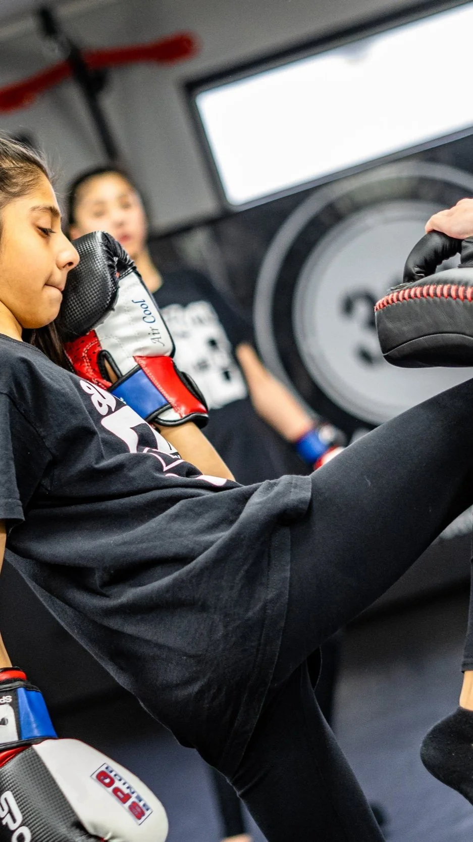 Girl practising striking and padwork at 313 Fitness