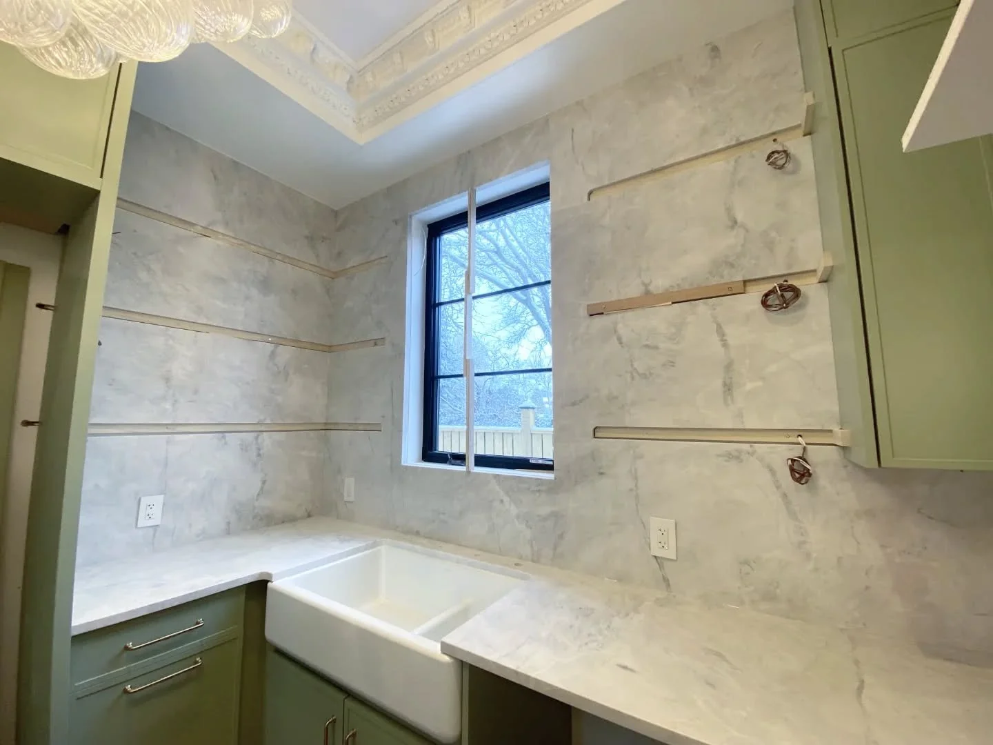 This Sky White Quartzite countertop flows seamlessly into a full-height backsplash, creating a clean, high-end look that&rsquo;s ready for the final touch: custom floating shelves by none other than @oakridgecabinets.ca 

#kitchendesign #reno #custom