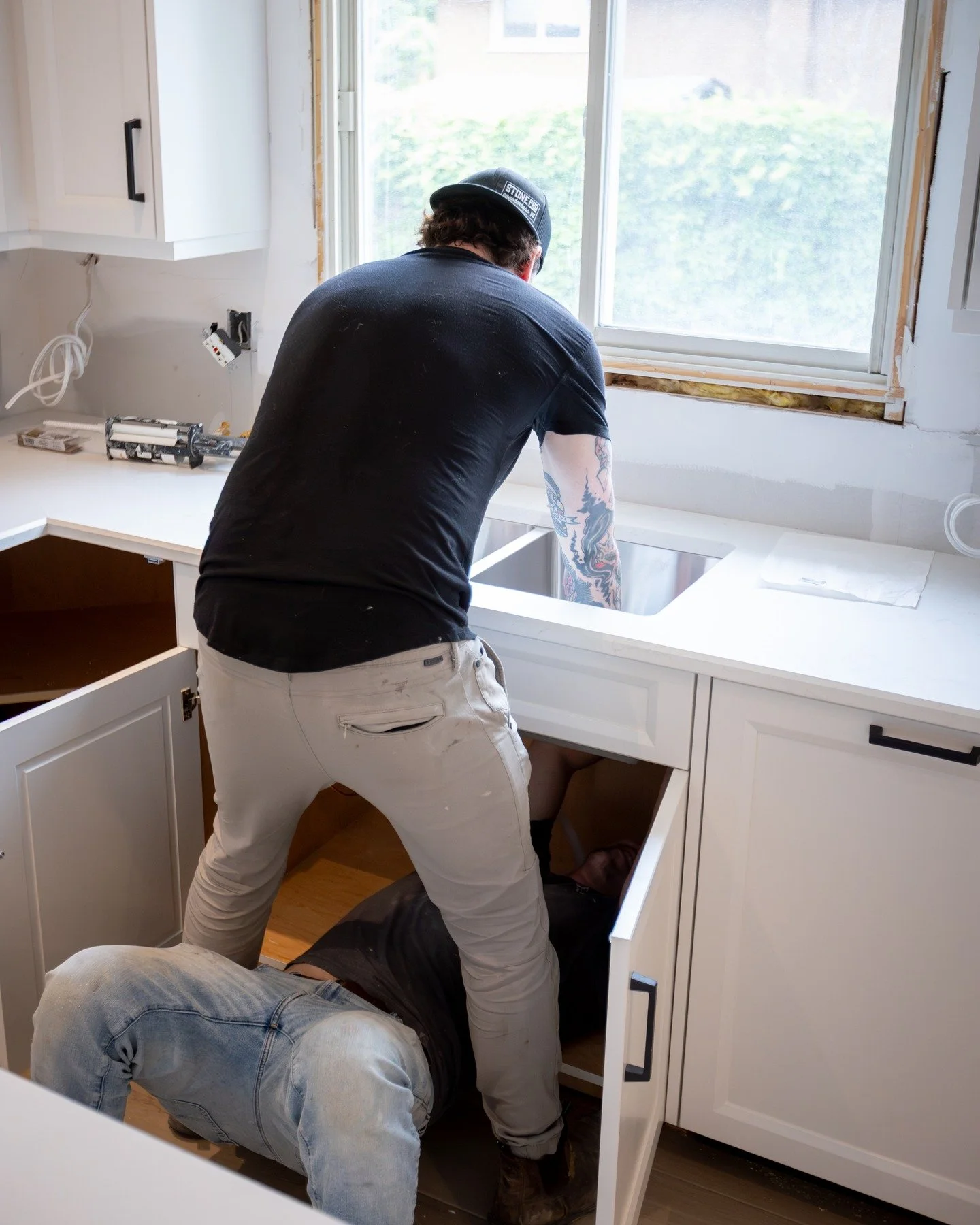 Caption this photo! Wrong answers only.

The right answer: This scene is repeated daily with our install team when we install our sinks. One installer holding the sink up and in place with silicone already along the edges to ensure water tightness. A