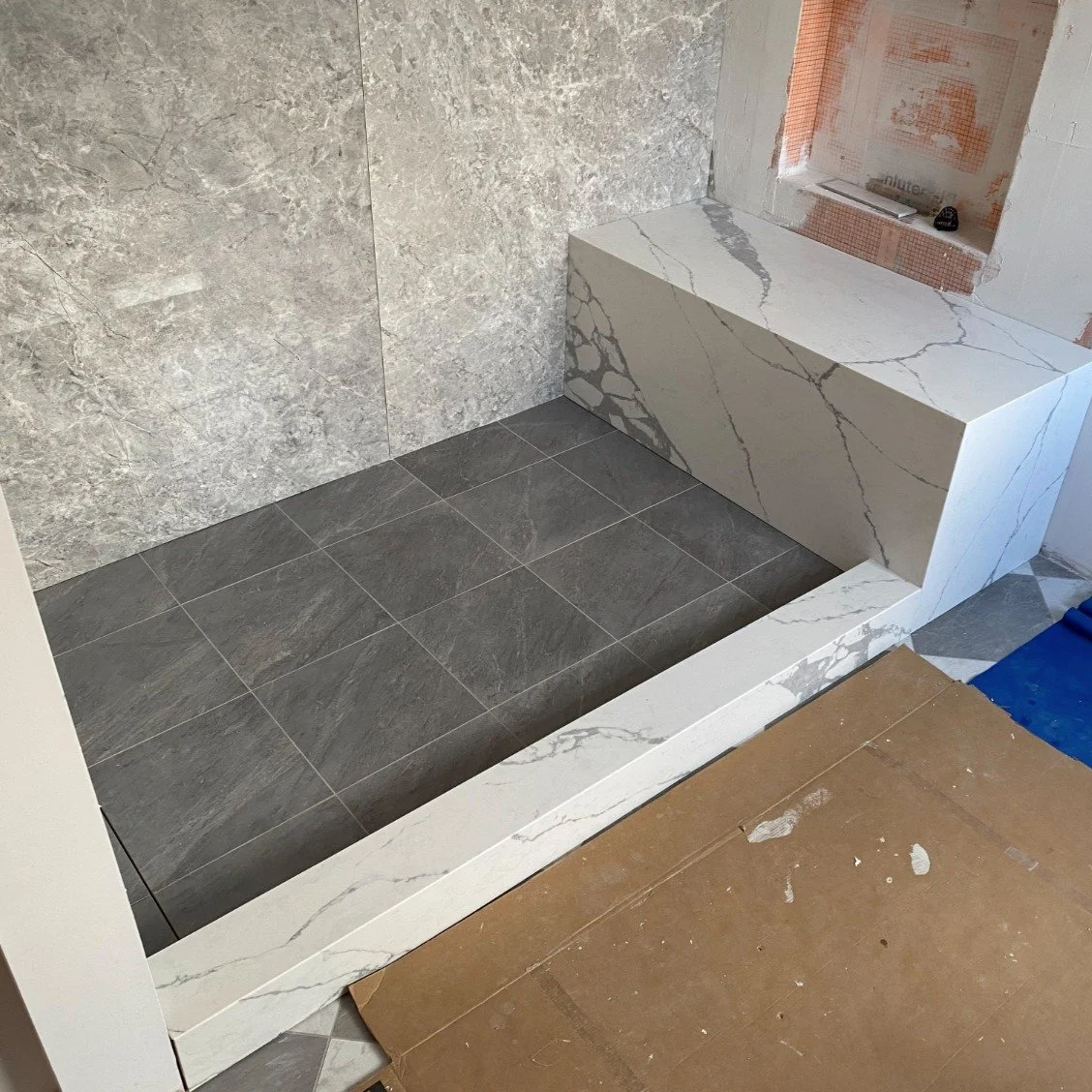 No more wiping down grout lines every time you step out. Smooth, waterfall quartz on your shower bench and sill means water glides off and cleaning takes seconds. It&rsquo;s the end of damp corners and the start of a bathroom that actually stays dry.