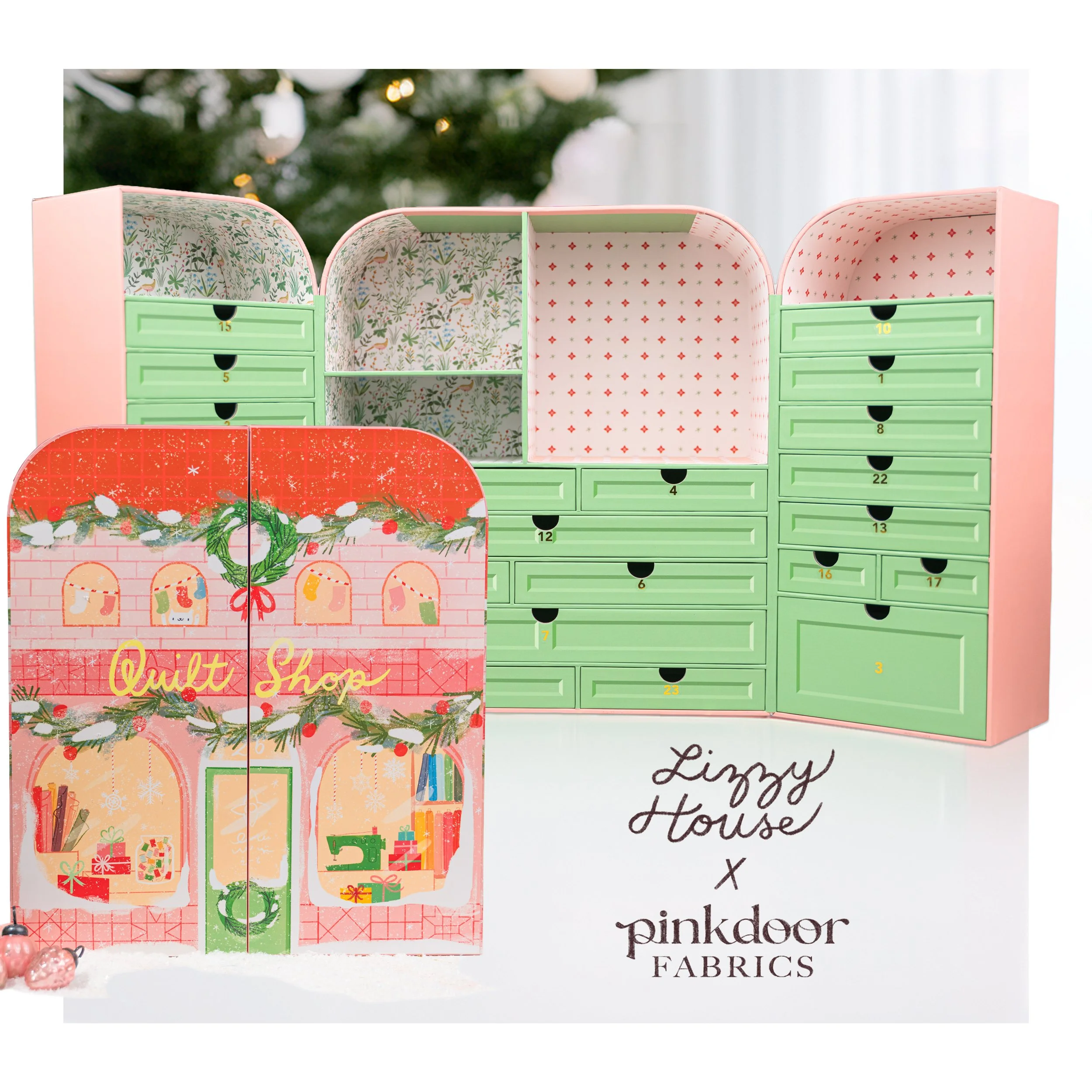 Image of a colorful Christmas-themed advent calendar with numbered drawers, decorated with holiday motifs and a festive background, promoting Pink Door Fabrics.