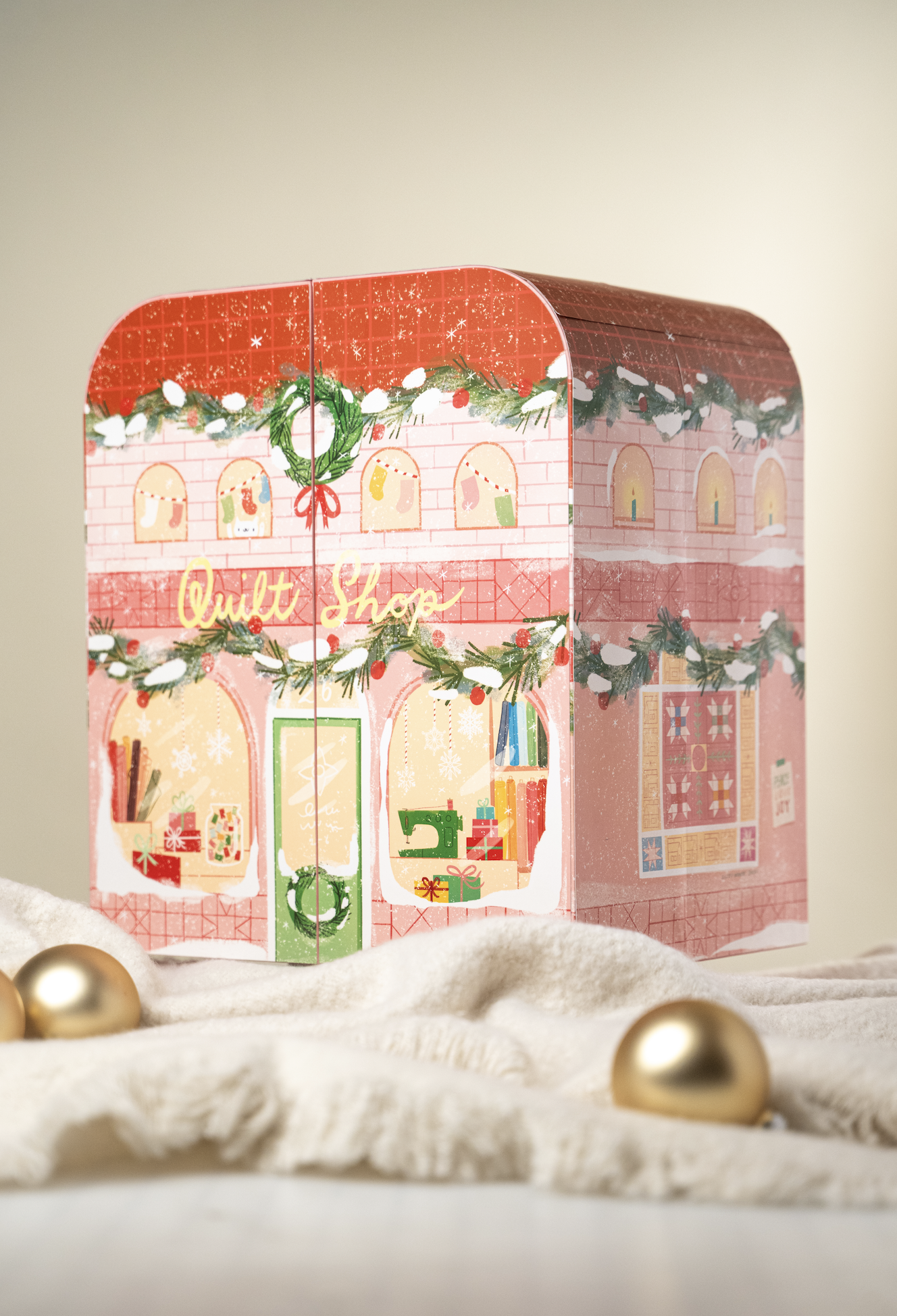 A decorative Christmas-themed Advent Calendar with holiday illustrations, set on a white surface with gold ornaments and a cream-colored background.