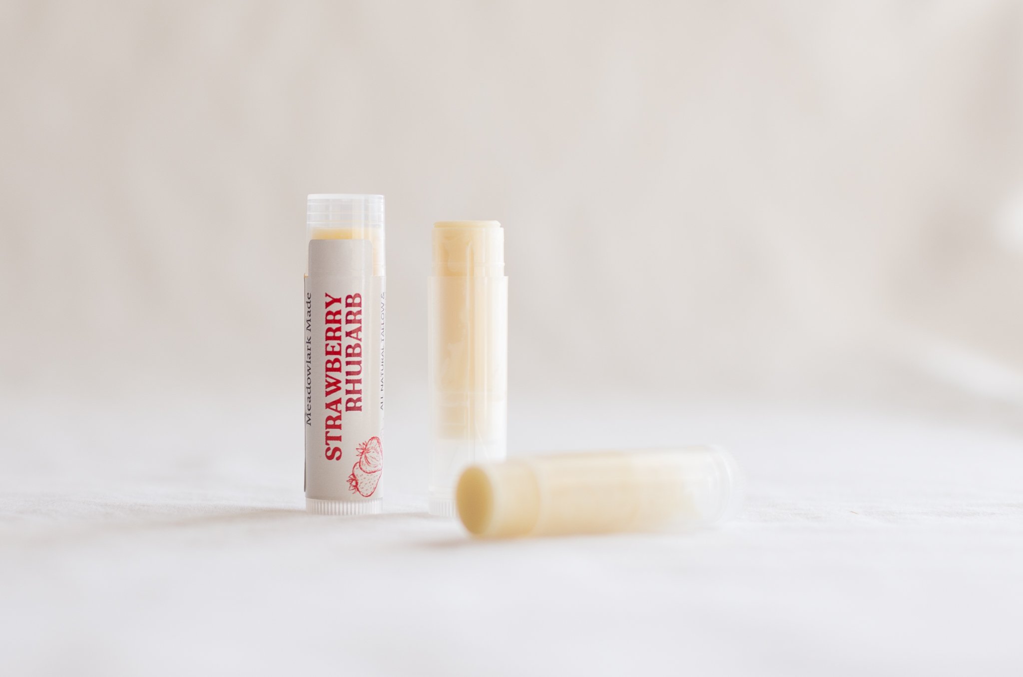 Strawberry Rhubarb limited edition lip balm by Meadowlark Made with pasture-raised tallow, local beeswax, and organic oils.