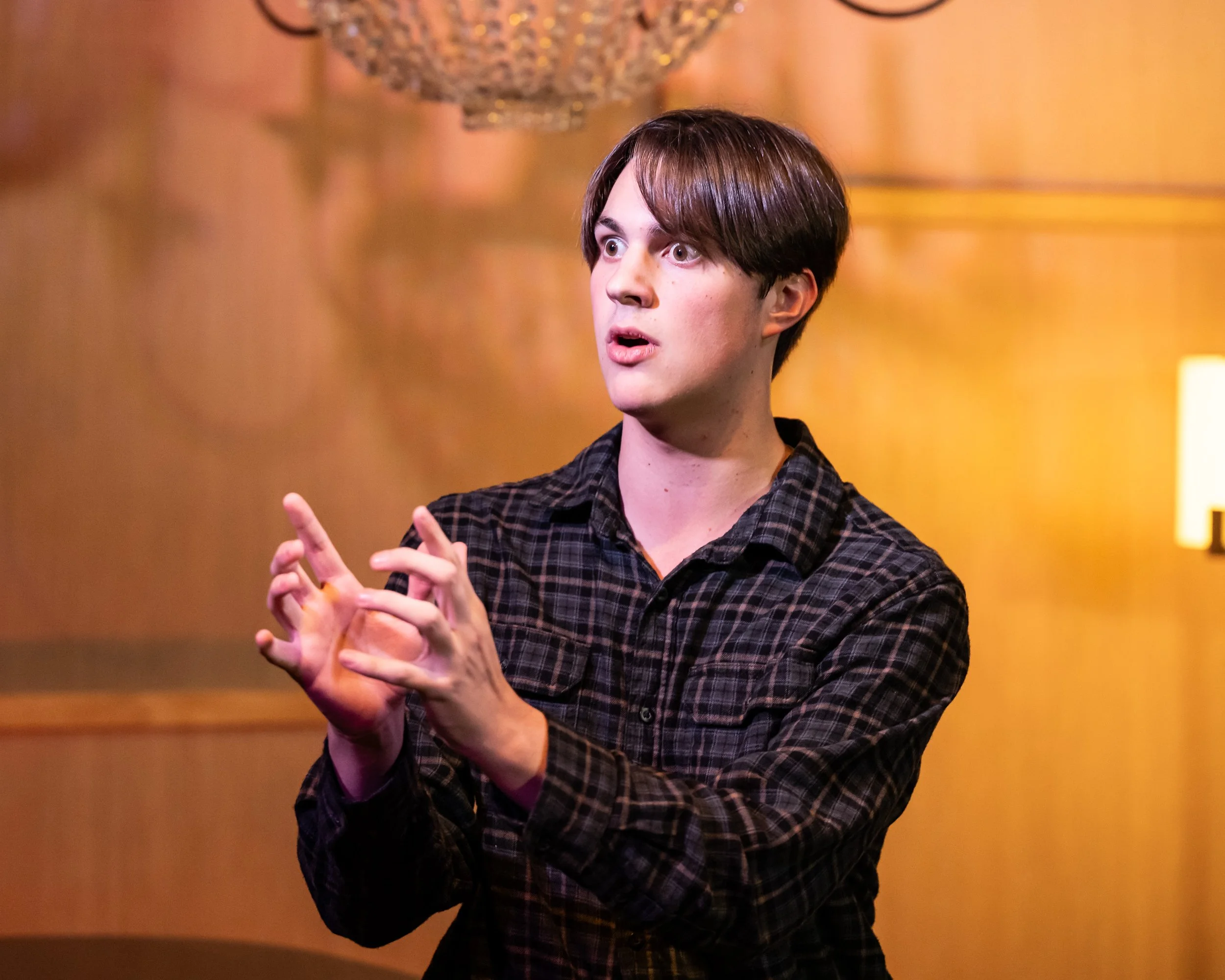 Glass of sparkling wine, pink flowers, a small pink gift box, headphones, and a yellow flower on a wire stand.