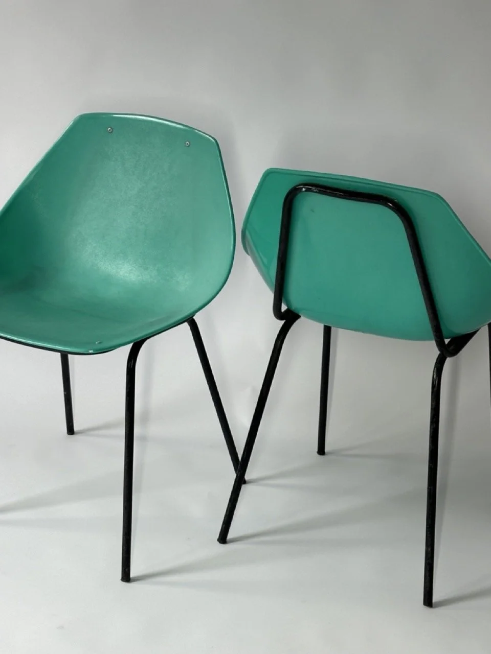 pair of turquoise Meurop Pierre Guariche shell chairs.jpeg