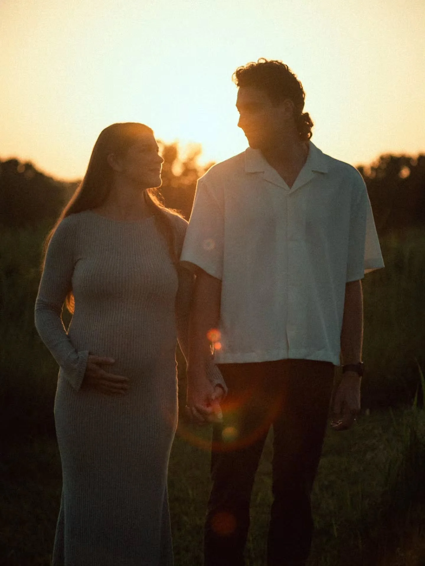 A year ago we were exploring rooftops and alleyways in downtown Springfield for Baylee and John's engagement photos. Then we braved the winter weather on their cold December wedding night. Now we're hiking through fields and chasing sunsets for their
