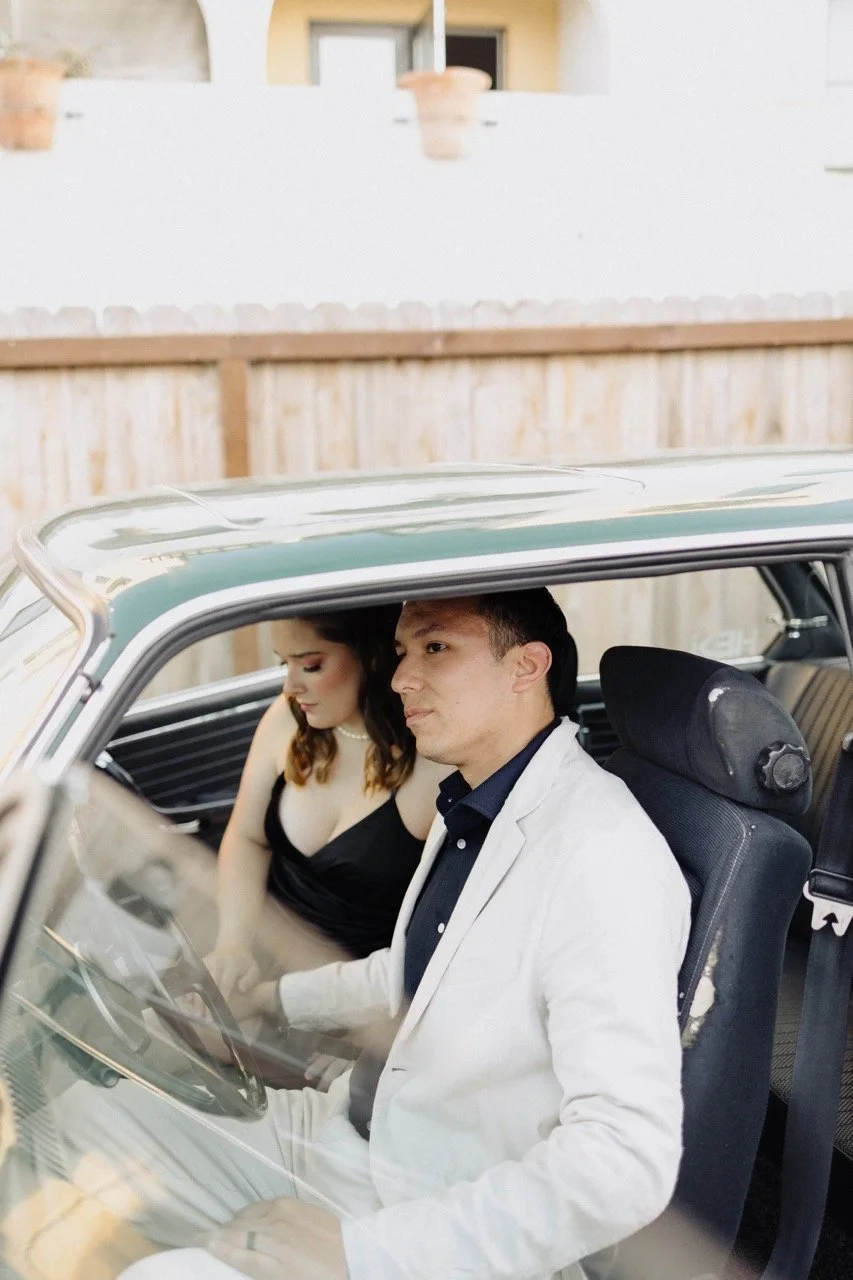 iowa city photographer in santa barbara,newlywed couple holding hands in a classic car