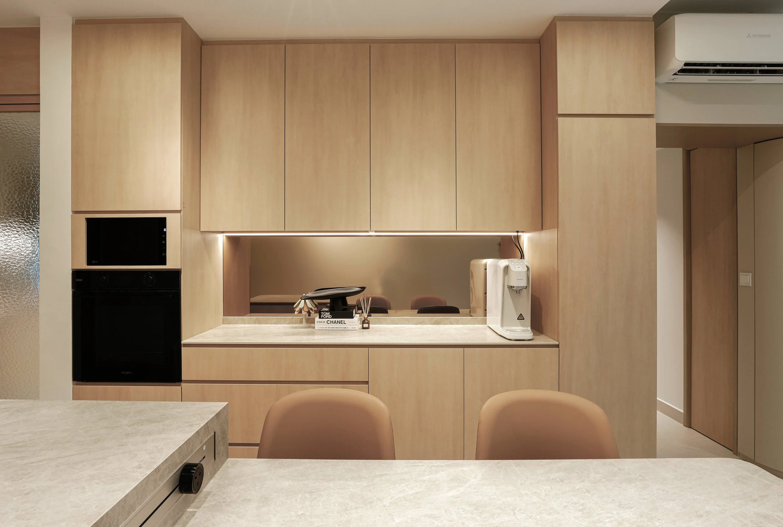 Minimalist living room design at Kovan Melody Condo with warm lighting, clean lines and serene MUJI-inspired interior concept Singapore
