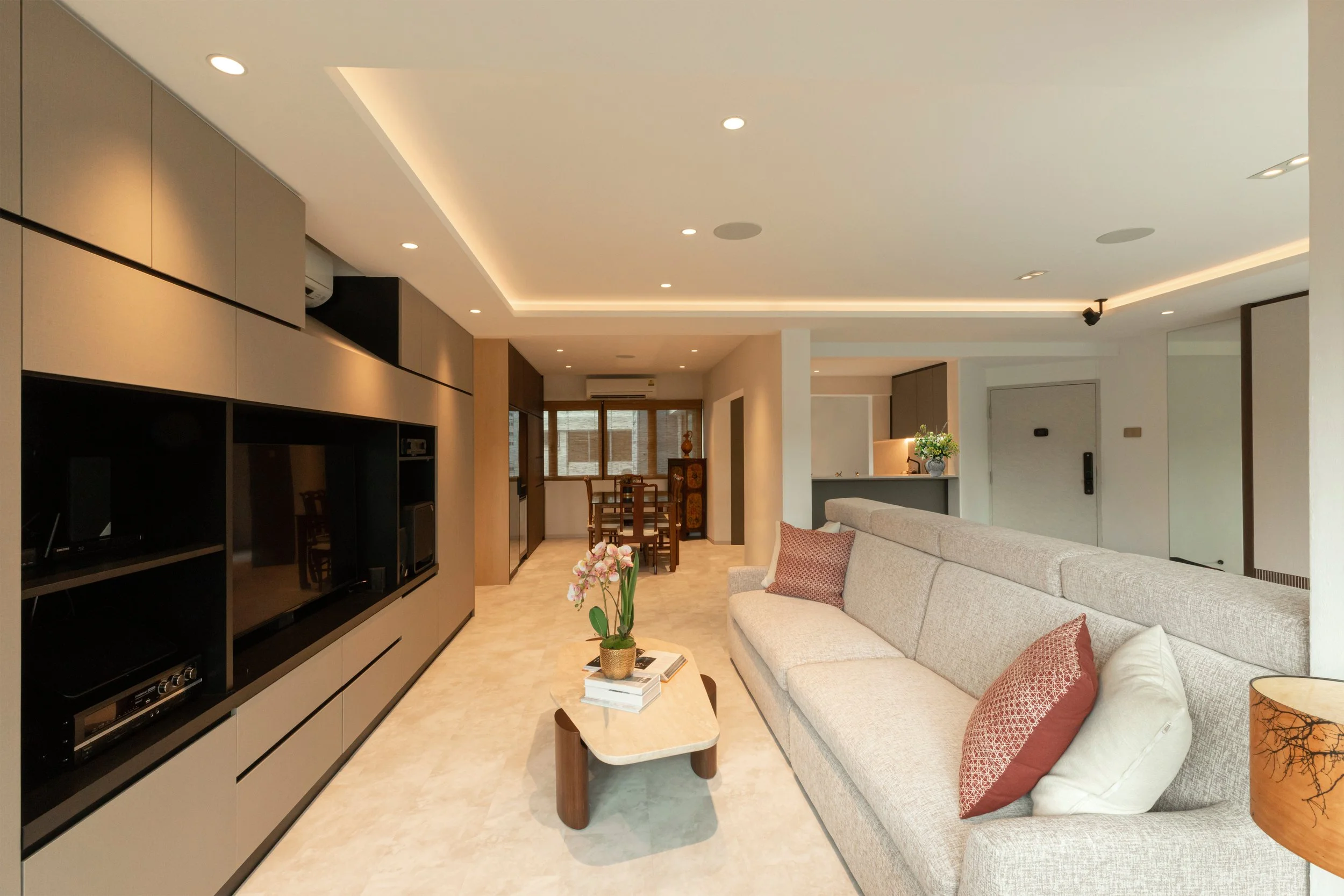Elegant Open concept Living area in Katong condo showcasing Japanese minimalist design, warm finishes and refined high-end interior styling