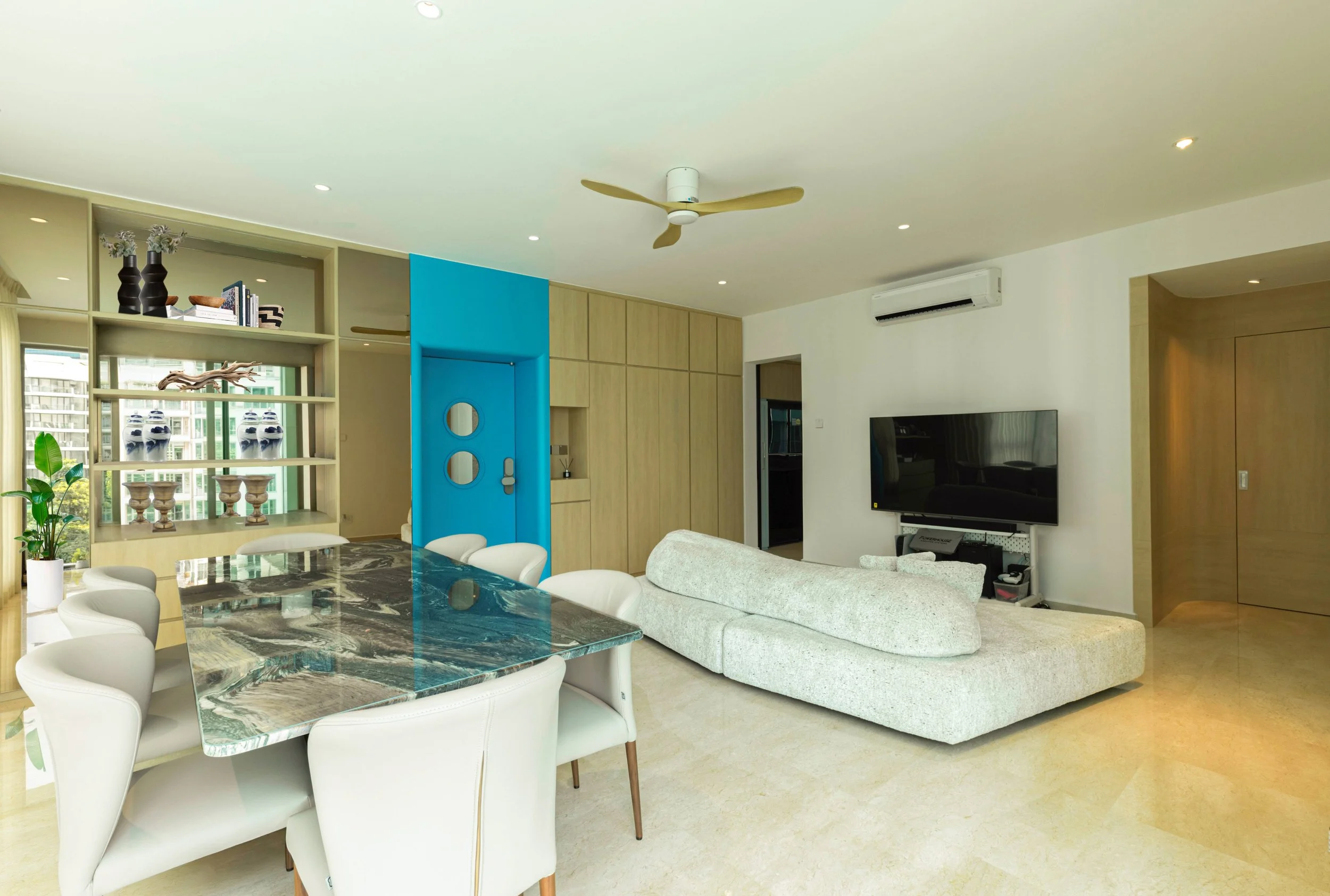 Elegant coastal dining area at Caribbean Keppel Bay Singapore designed with modern luxury interior concept, soft textures and seamless connection to living space