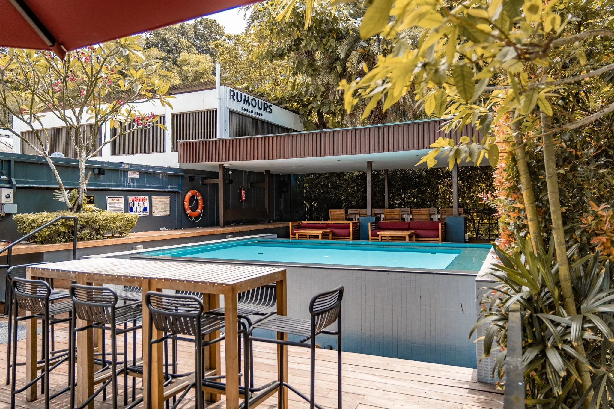 VIP pool lounge at Rumours Beach Club Sentosa featuring relaxed seating by the pool, tropical styling, shaded areas and a comfortable social atmosphere in Singapore
