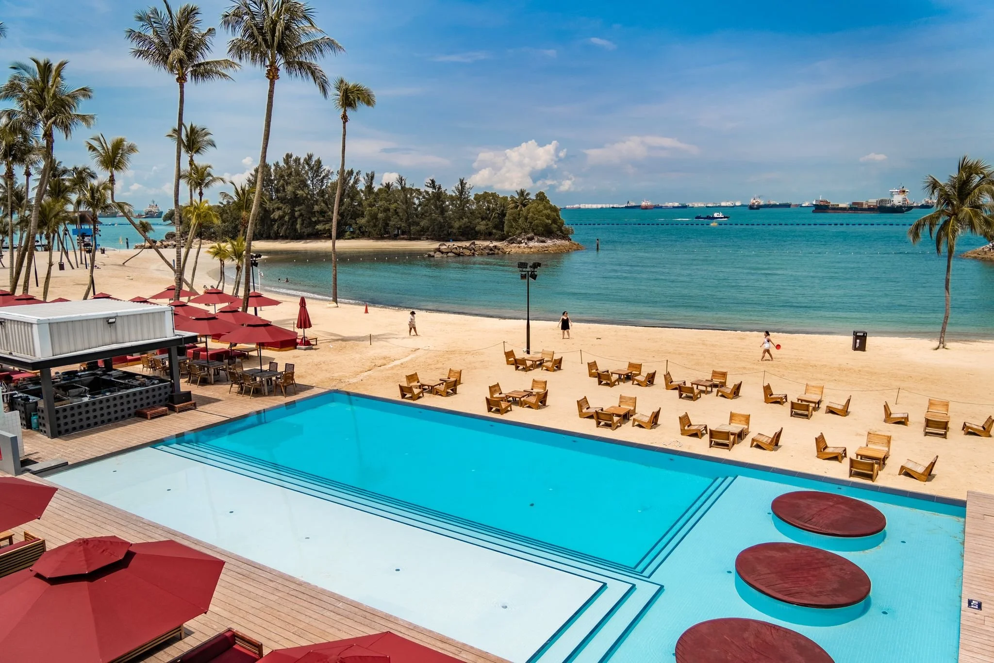 Lounge seating area at Rumours Beach Club Sentosa designed for comfort with soft furnishings and tropical design elements