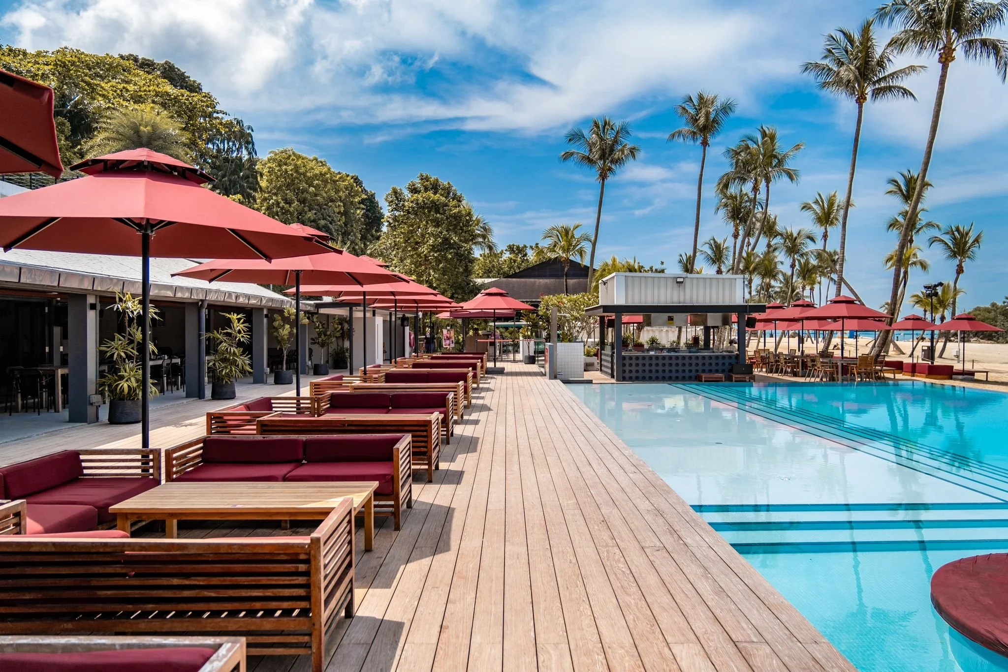 Dining area at Rumours Beach Club Sentosa with open seating, natural textures and relaxed beachside ambience