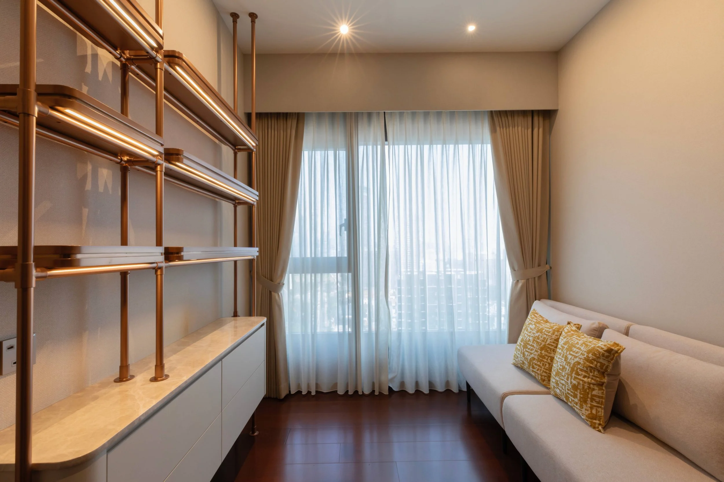 Cozy guest room in Midtown Modern condo designed with soft tones, efficient layout and practical storage solutions