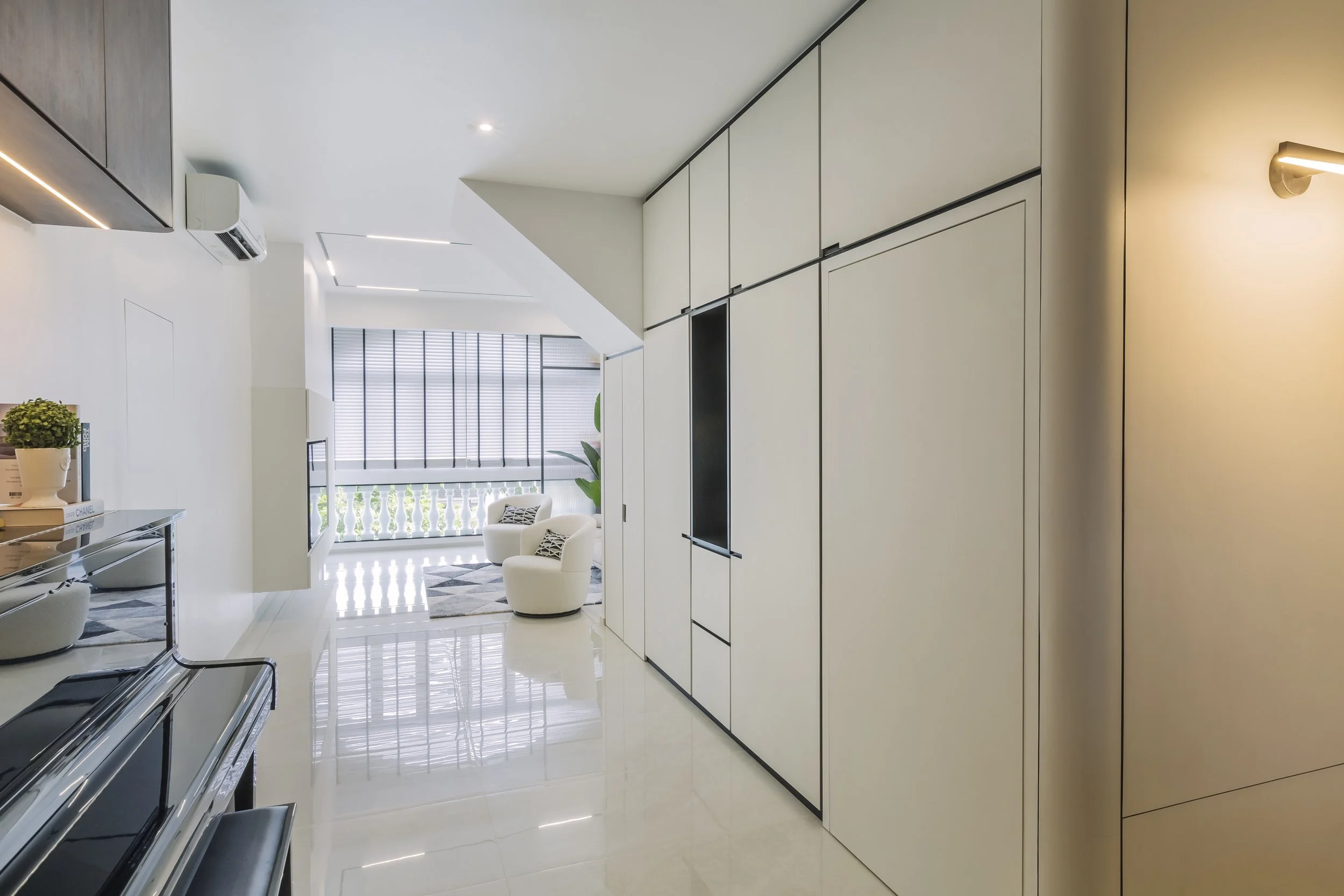High-end condo living space in Sin Ming Singapore with warm tones, custom carpentry and modern European interior styling