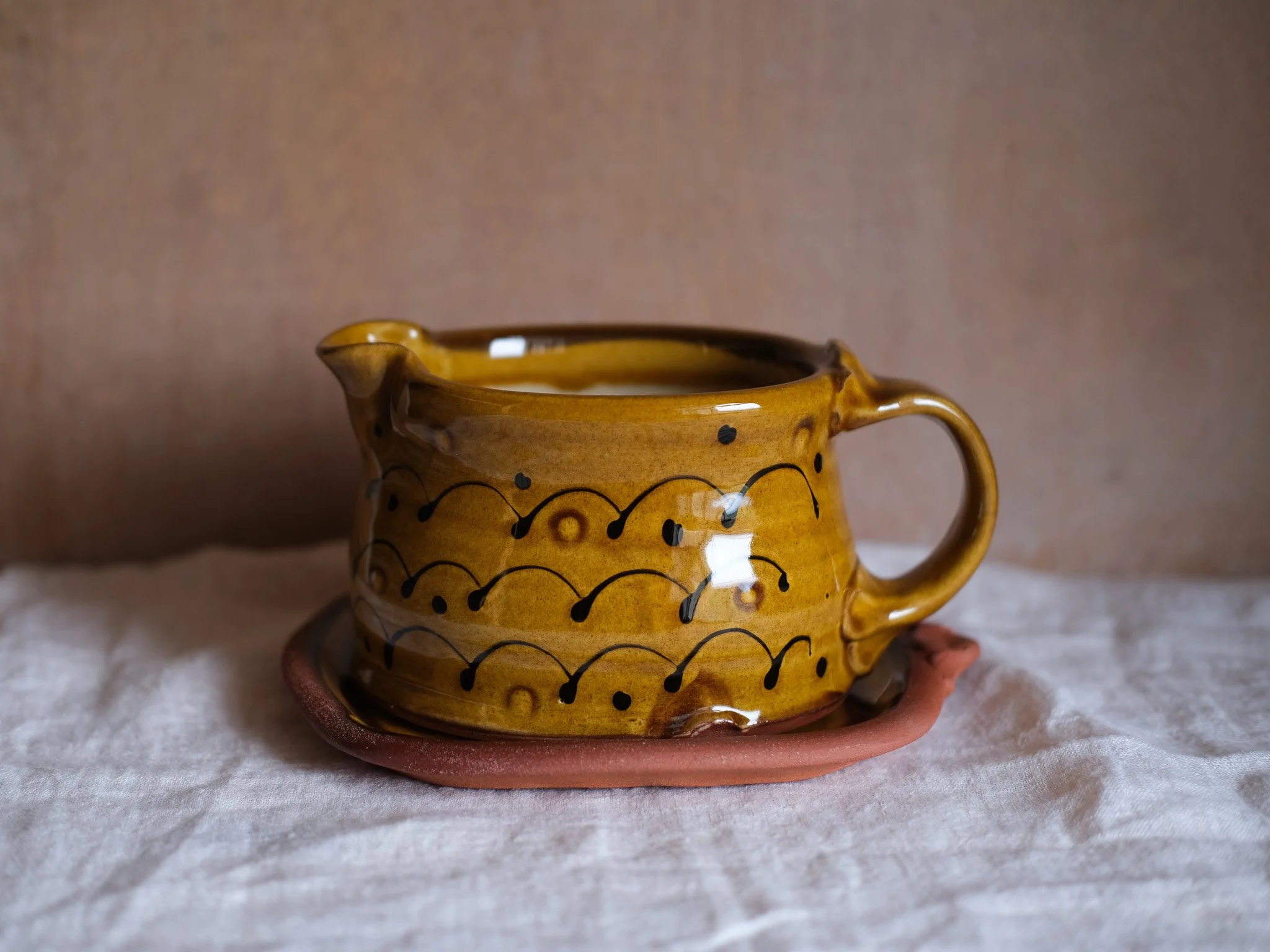 Honey Slip-Trailed Gravy Jug and Saucer