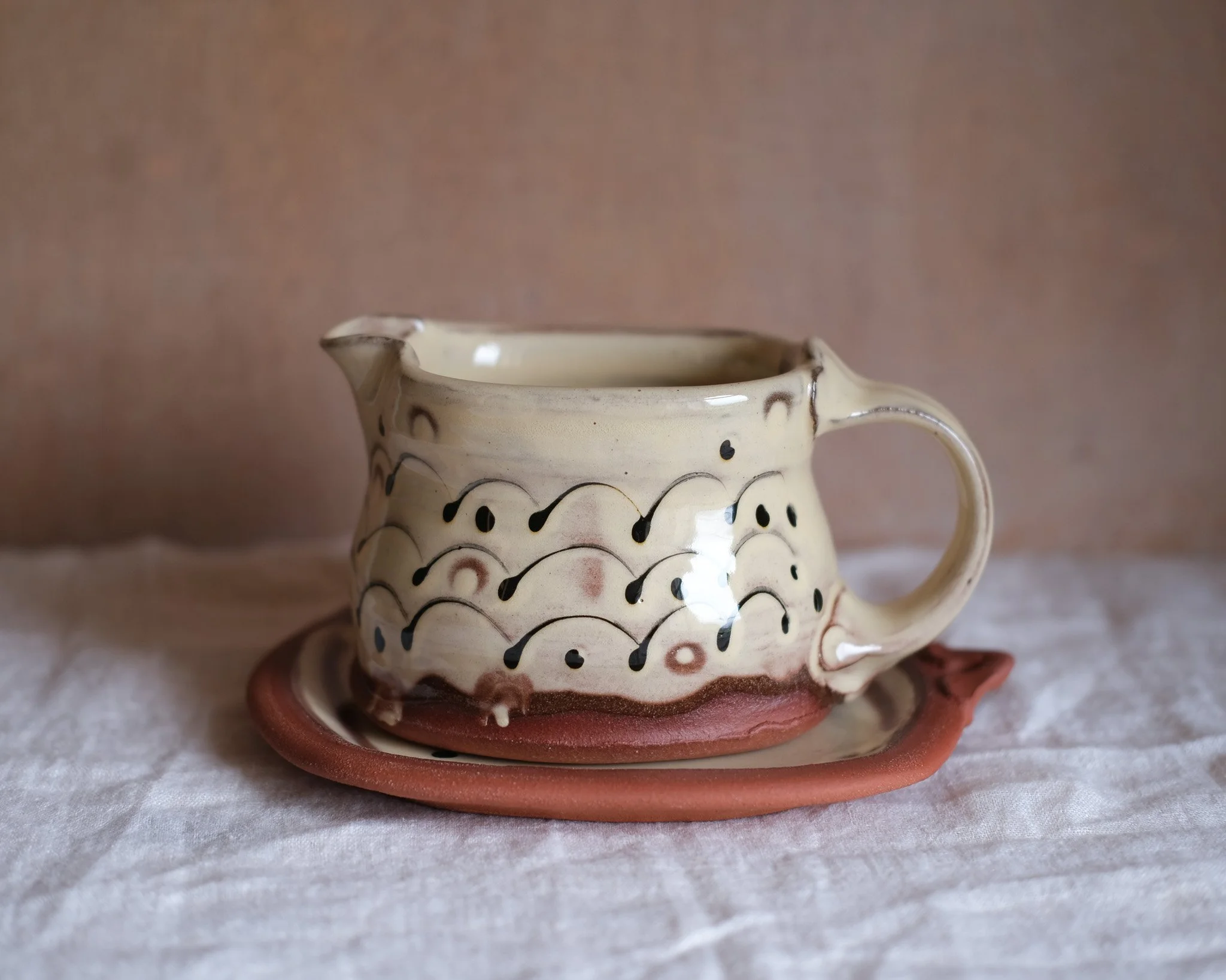 Slip-trailed Gravy Jug and Saucer