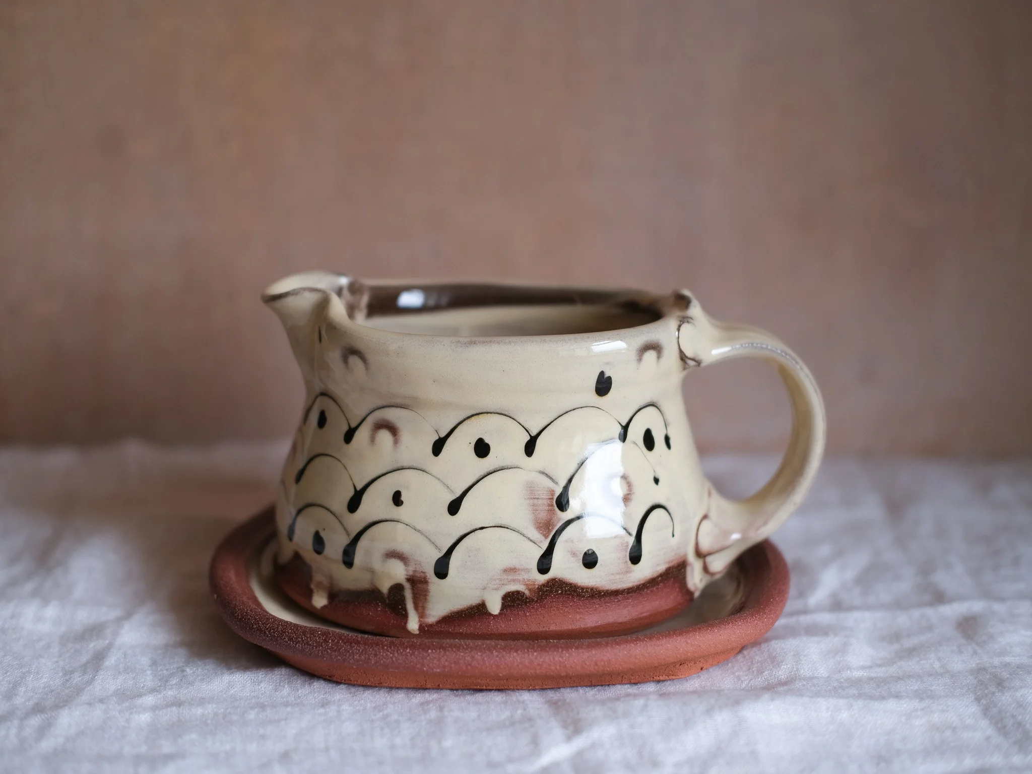 Slip-trailed Gravy Jug and Saucer