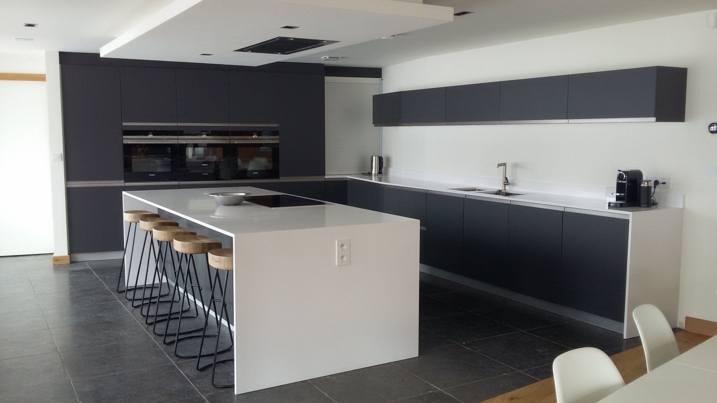 Our client wanted a sleek contemporary kitchen with waterfall island and dropped ceiling extraction.