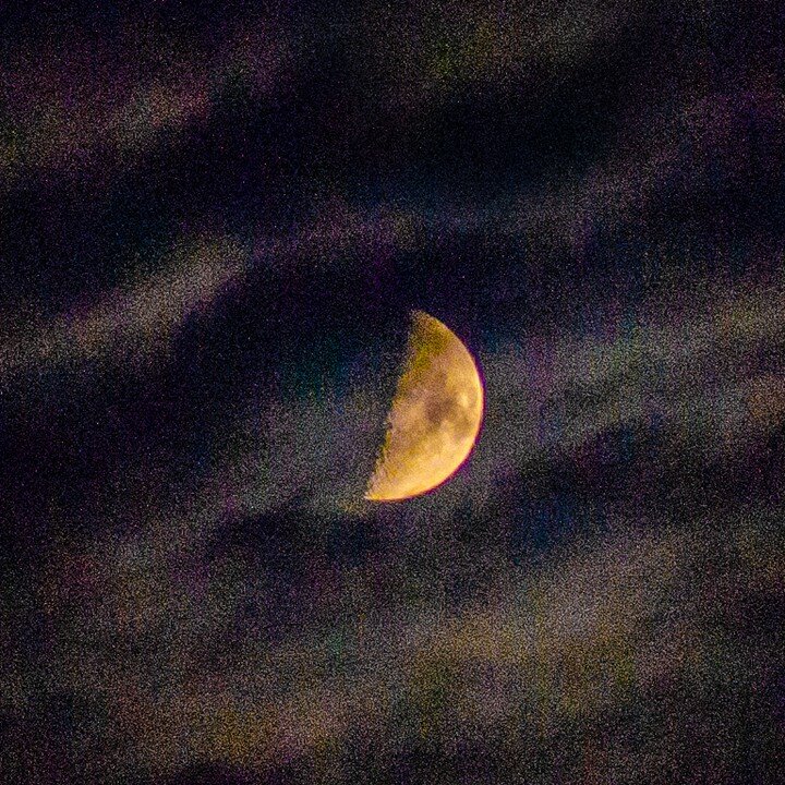 A slice of cold moon, out-raced by outstretched arms of clouds, seeks the western horizon.