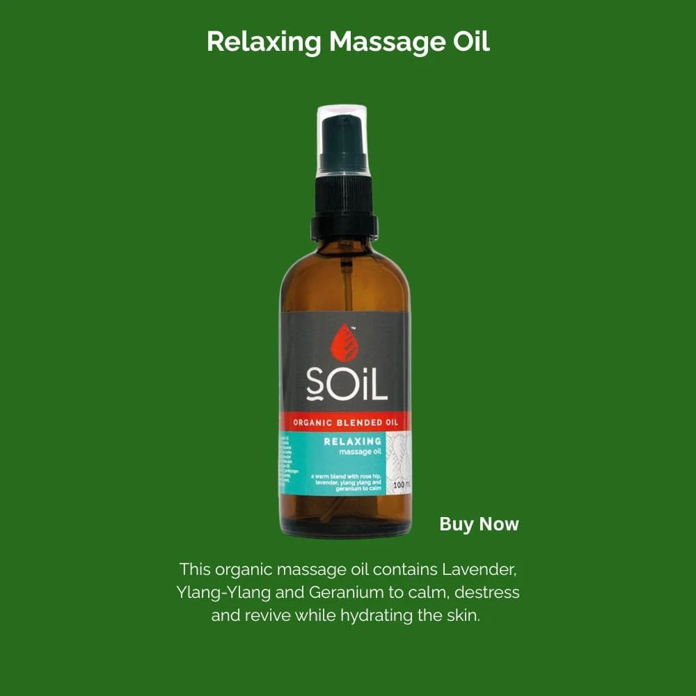 Bottle of SOiL Relaxing Massage Oil with a spray top, on a green background. Text indicates it's an organic blended oil containing lavender, ylang-ylang, and geranium, for calming and hydrating skin.