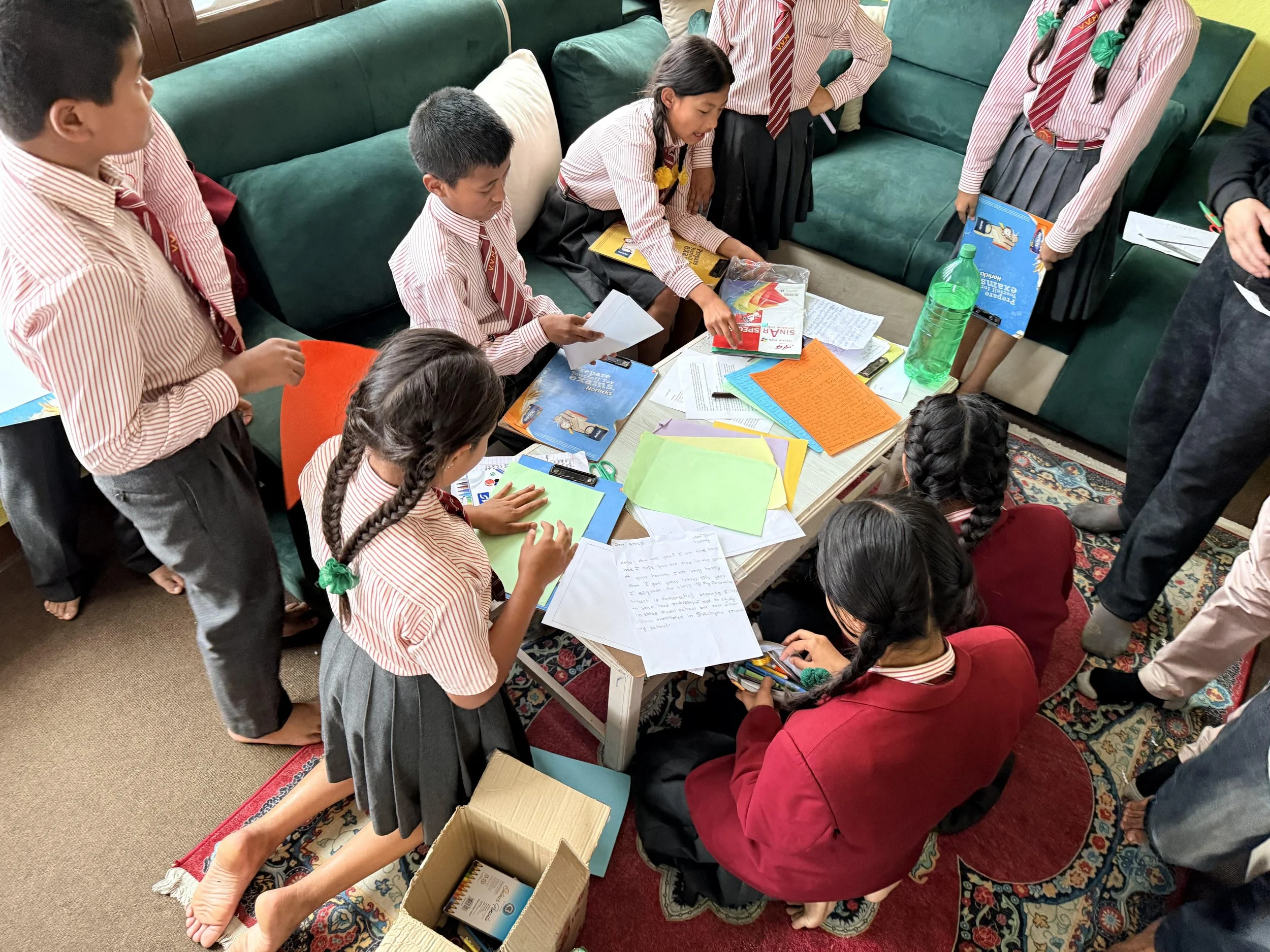 Students writing letters to their sponsors.