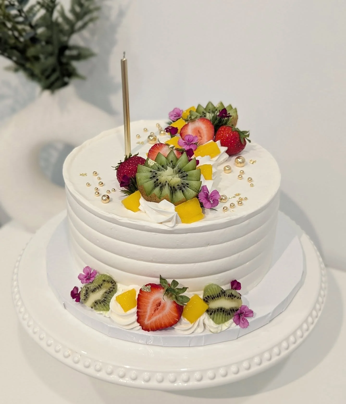 Every year my husband asks for the same fruit cake. Layers of vanilla cake, strawberry compote filling and fresh fruit inside. Without fail every year he doesn't get a piece to eat. As soon as he cuts it we serve it to the guests and this year I made