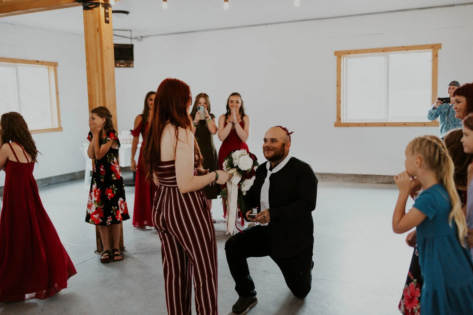 The groom’s brother surprises his girlfriend with a proposal at the end of the bouquet toss