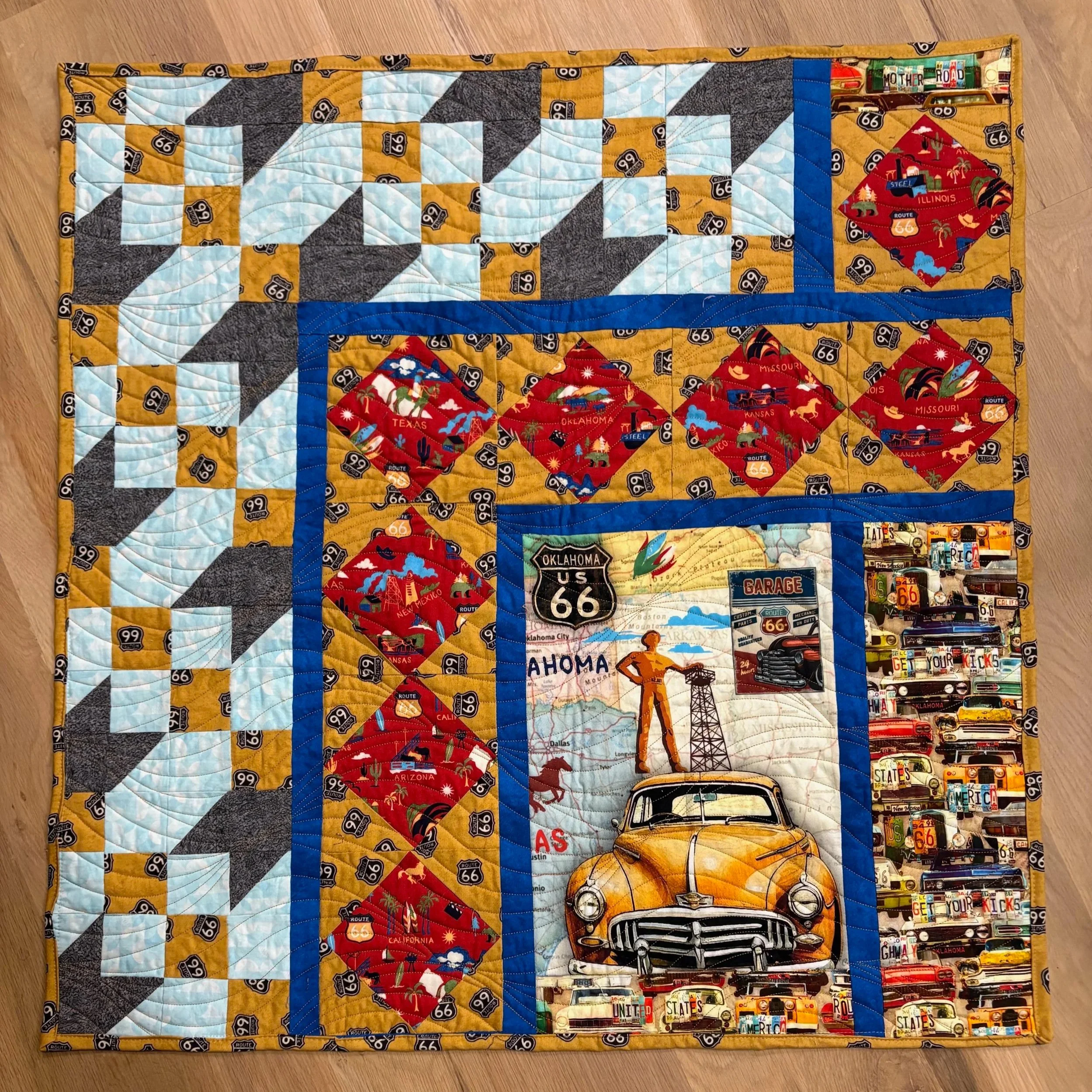 Route 66:  The Road To Oklahoma: It's' All About Cars
by Rene Norman
*
The Road To Oklahoma quilt blocks (top and left side of quilt) evoke driving Route 66 on a pleasant day.  The "Square in a Square" blocks (red and gold) name all 8 of the states w