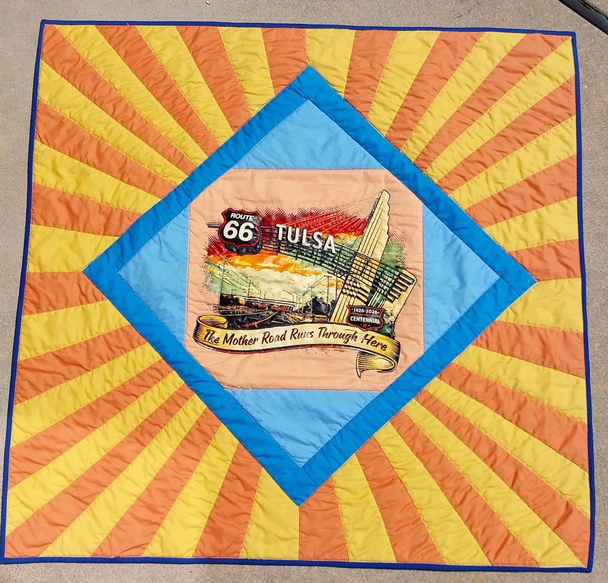 Sunshine on Route 66 in Tulsa 
by Monica Macklin
*
This quilt combined  a Route 66 t-shirt design, the colors from the NIT basketball logo/ high school announcement, and  the design of a Route 66 sign.