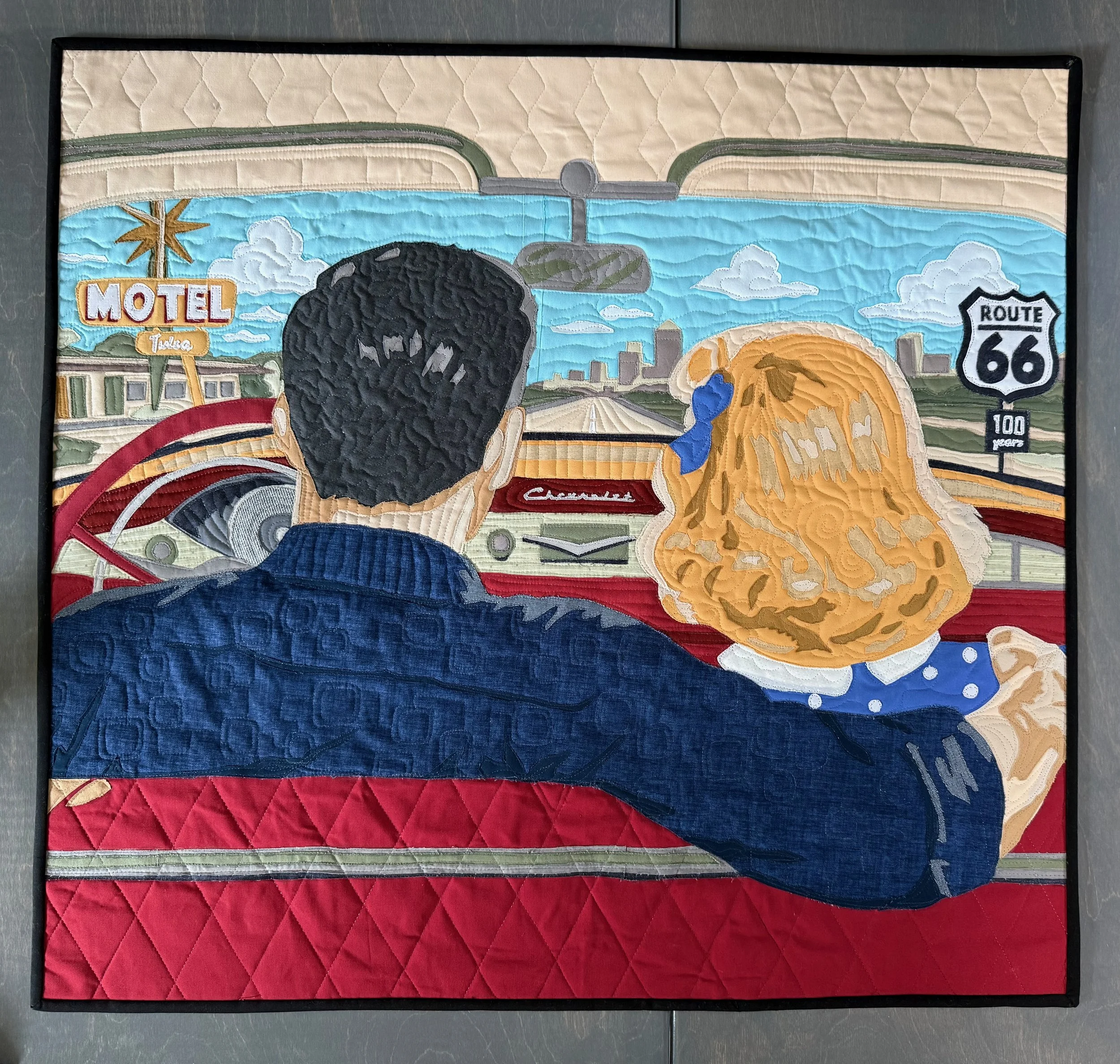 Cruising the Mother Road
by Holly Yeagle
*
Inspired by memories of my parents, the raw edge applique quilt depicts Tulsa natives, Ray and Jean McCollum, cruising Route 66 on a carefree Saturday night and the road's neon lights. The Mother Road (11th 