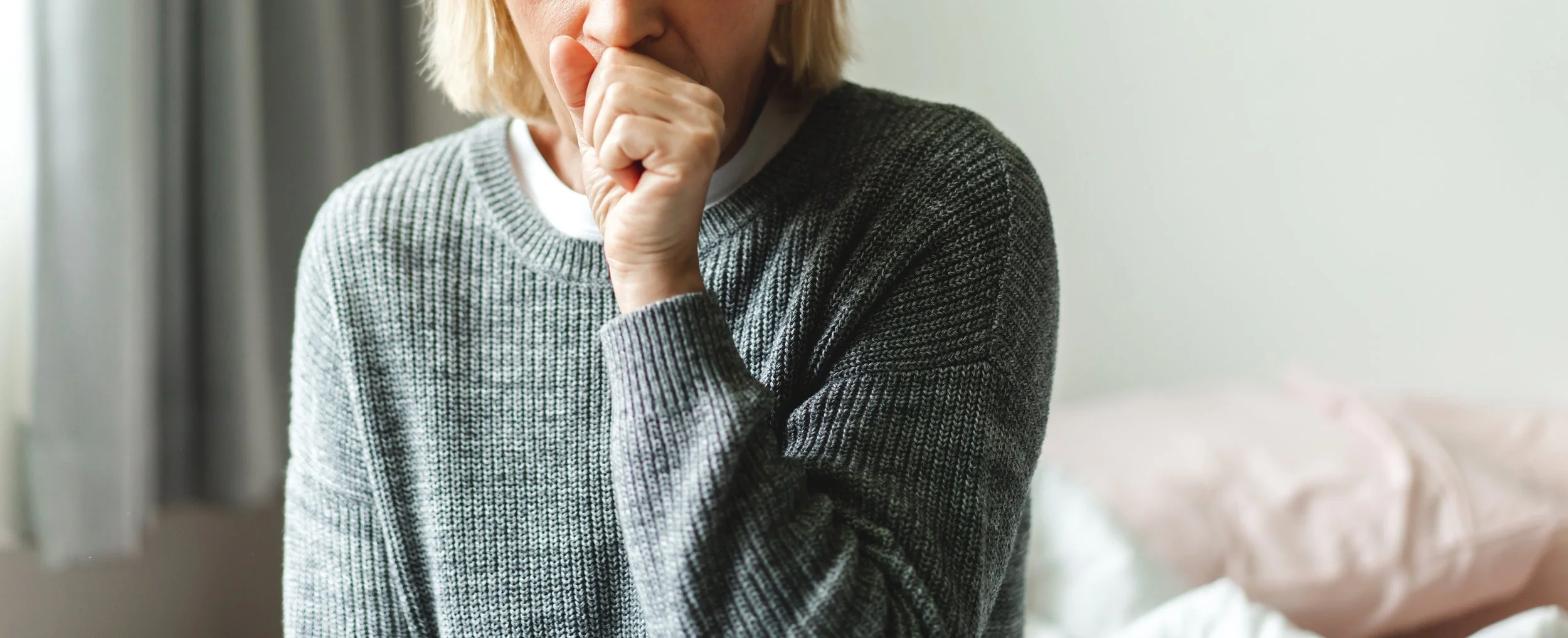 Elderly woman with secondary asbestos exposure coughing