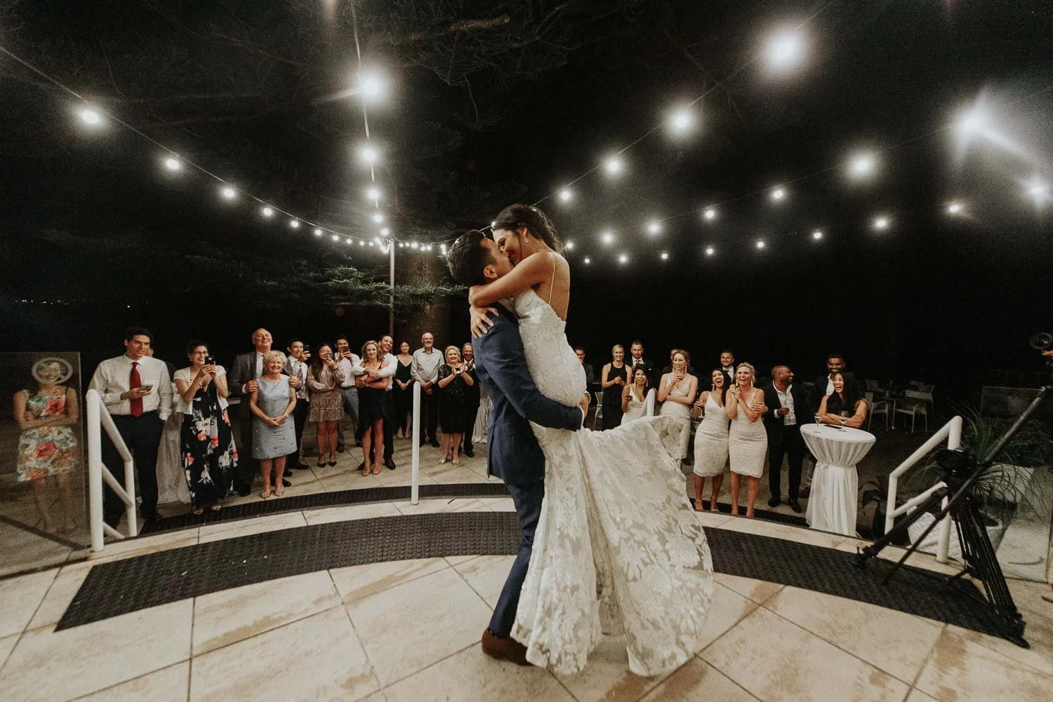 first dance bride and groom at Long Reef Golf Club with fairy light - groom lifting bride