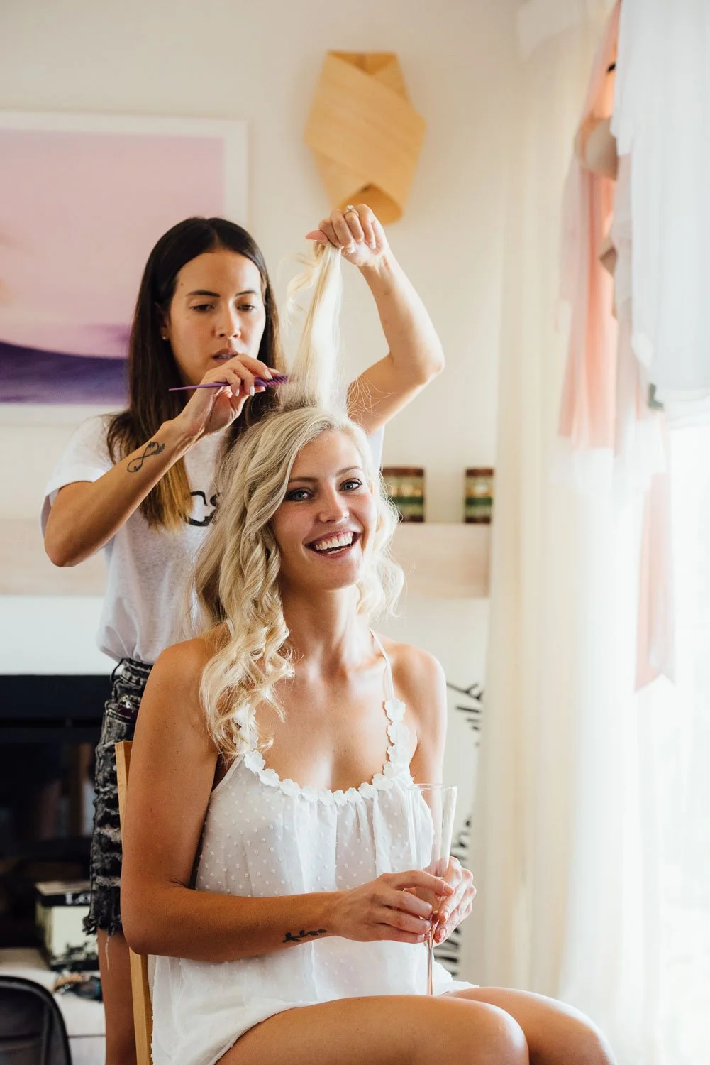 bride getting ready with hair dresser